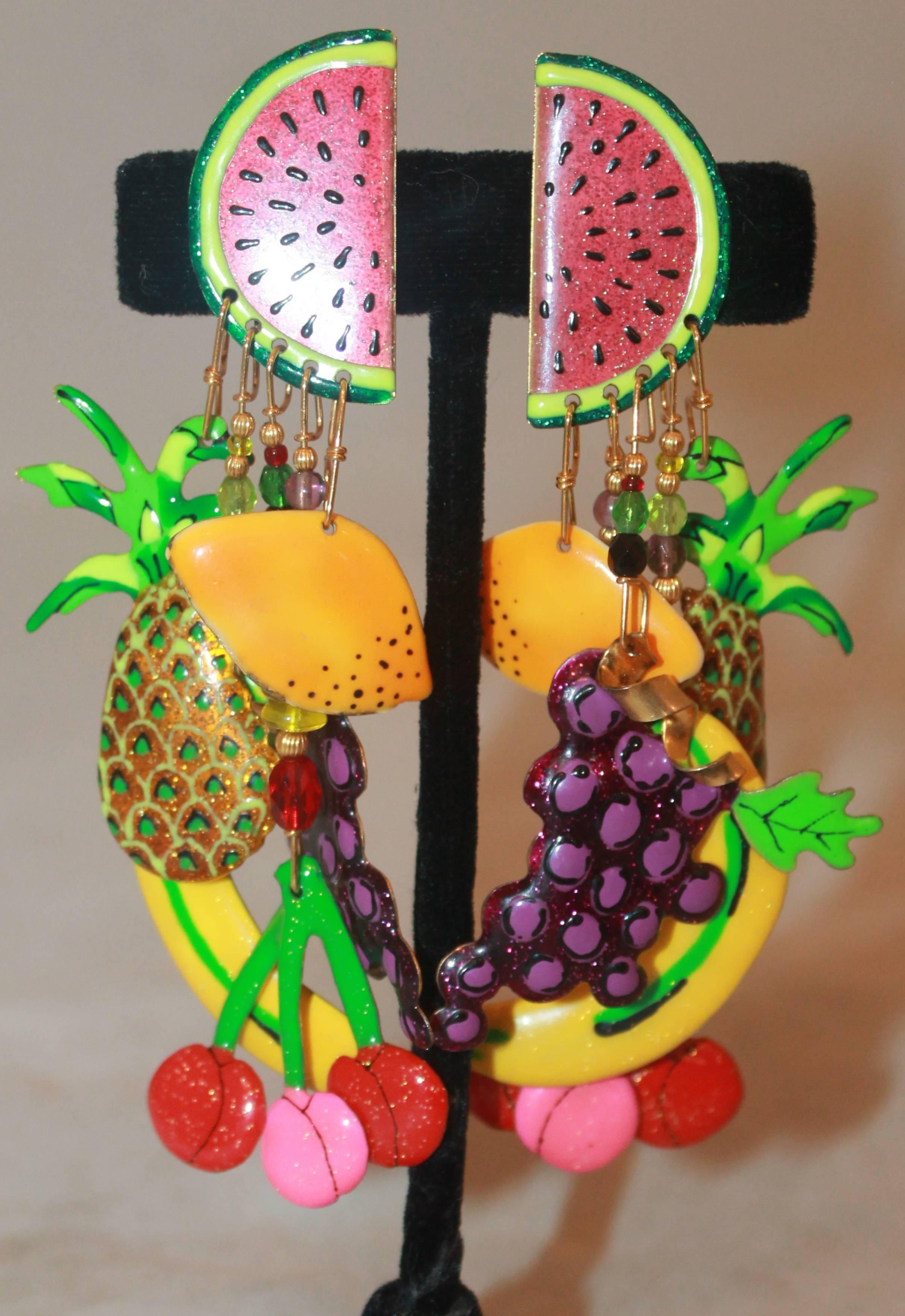 Lunch at the Ritz Multi-Colored Fruit Themed Dangle Clip-On Earrings-Circa 1990's.  These fun earrings are in excellent condition.  They feature a fruit theme including watermelon, cherries, grapes, bananas, pineapples, and oranges.  The enamel has