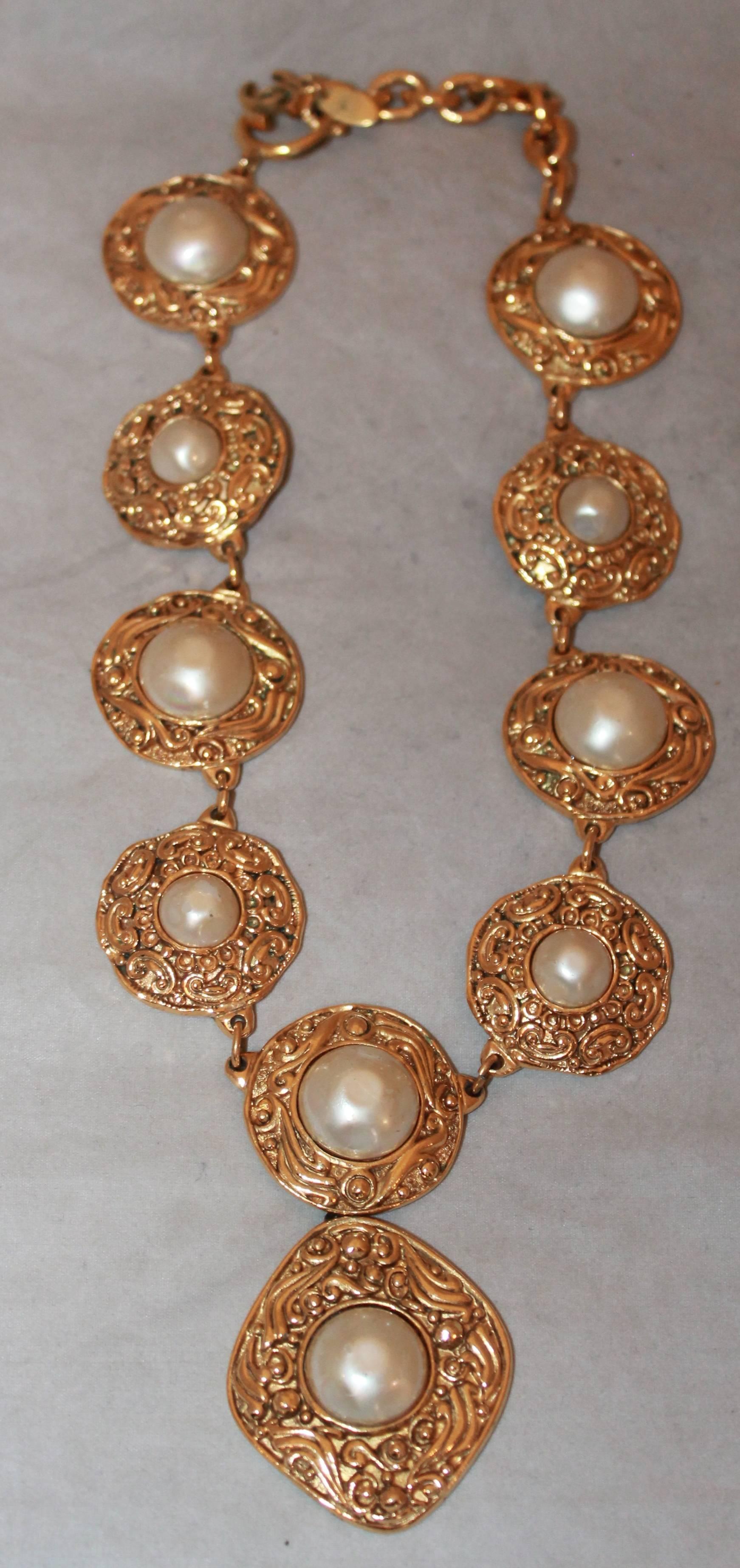 Chanel 1970's Goldtone & Pearl Medallion Necklace.  This stunning Chanel necklace is in excellent vintage condition.  It features ten medallion pieces, with the bottom most one having a more rounded diamond shape.  This piece is from the late