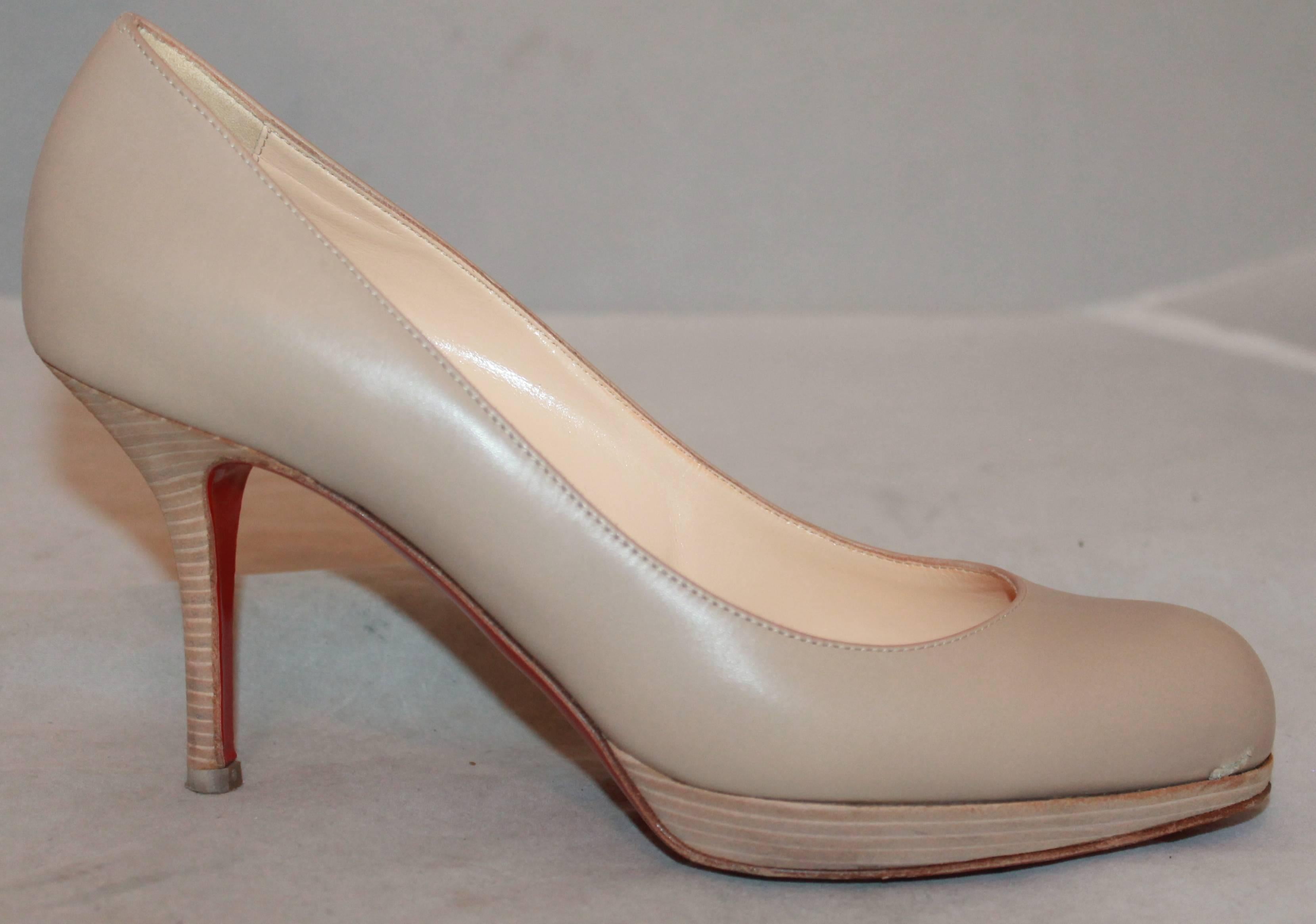 Christian Louboutin Nude Leather Wooden Pumps - 37.5. These pumps are in fair condition with some wear to the leather and more visible wear seen on the back of the heel. The bottom also has some minor wear and one area of a pump has a scuff as shown