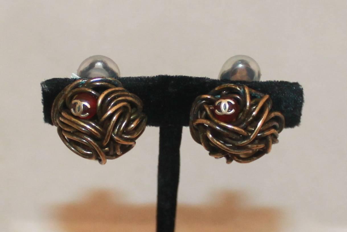 Chanel Woven Goldtone Wire Clip-On Earrings w/ Pearl & Red Gripoix - Circa 1997.  These lovely Chanel earrings are in good vintage condition with only some discoloration on the woven metal and some green on the back.  They feature an intricately