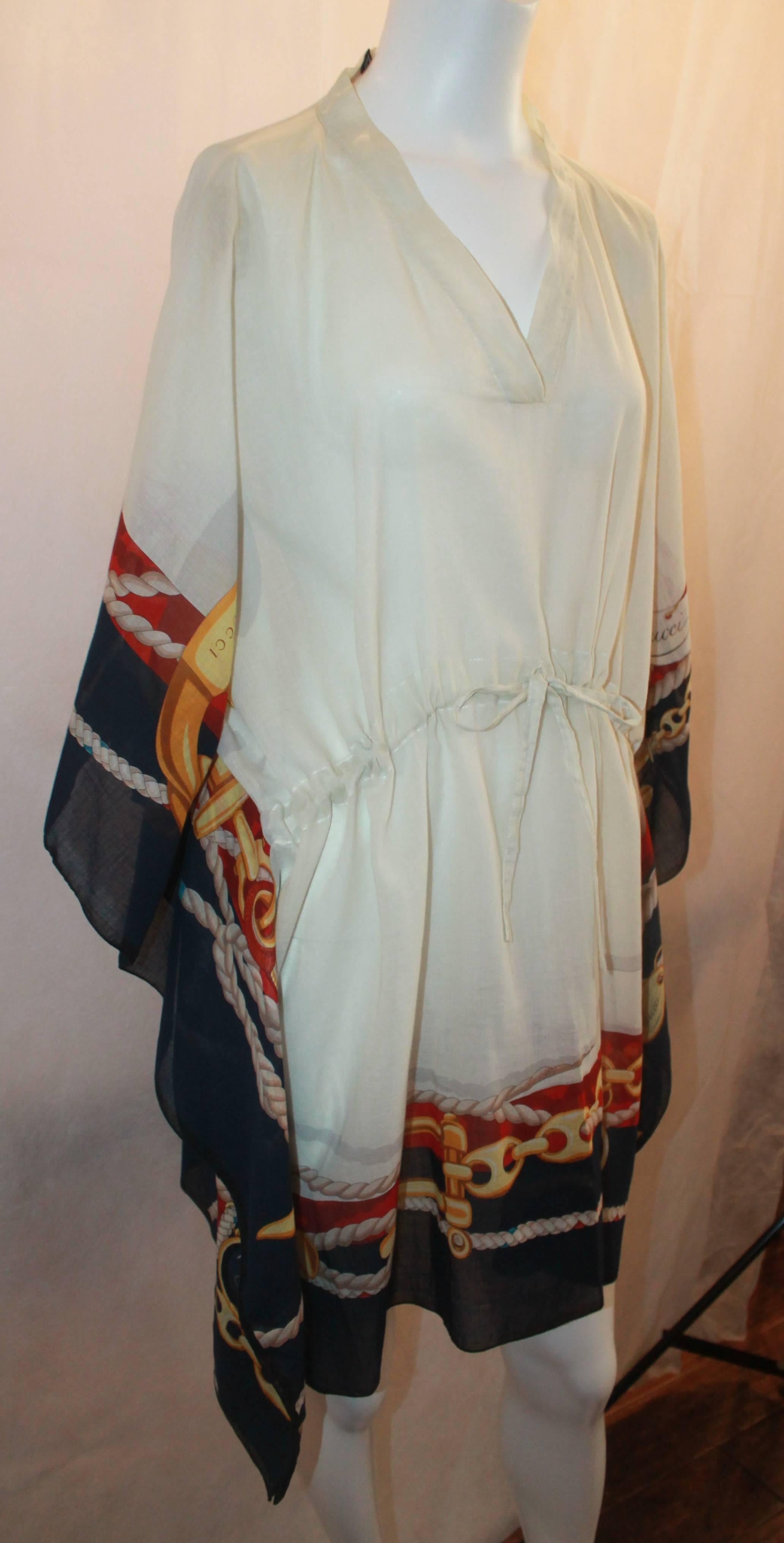 Gucci Ivory Cotton Caftan with Red & Navy Trim and Chain Detail - M. This piece is in excellent condition and is a must-have for summer! Perfect for a beach day or pool-side relaxing. The sheer fabric has a chain-like print on the edges with a rope