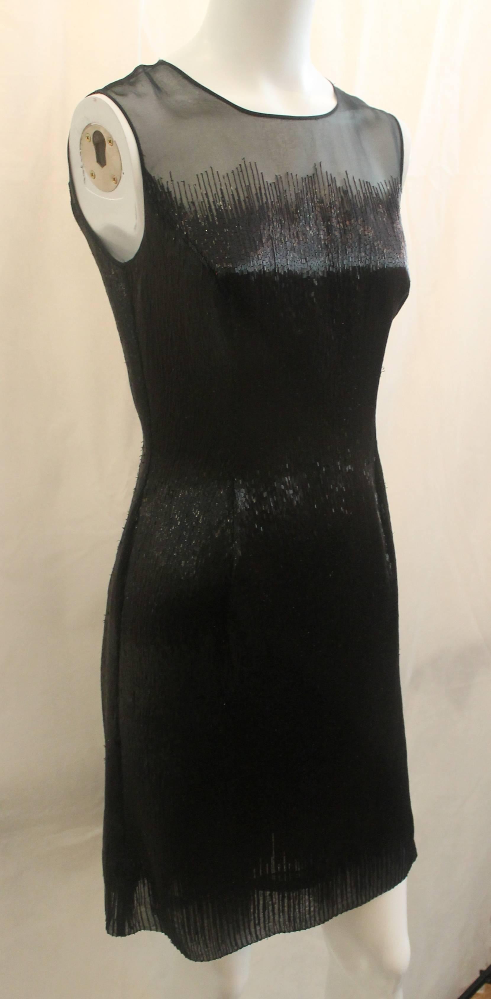Oscar de la Renta Black Fully Beaded Sleeveless Dress - 2. This dress is an exquisite piece with a sheer top turning into beading. This dress features to non-beaded slits in the back and a form fitting look.

Measurements:
Bust- 32.5
