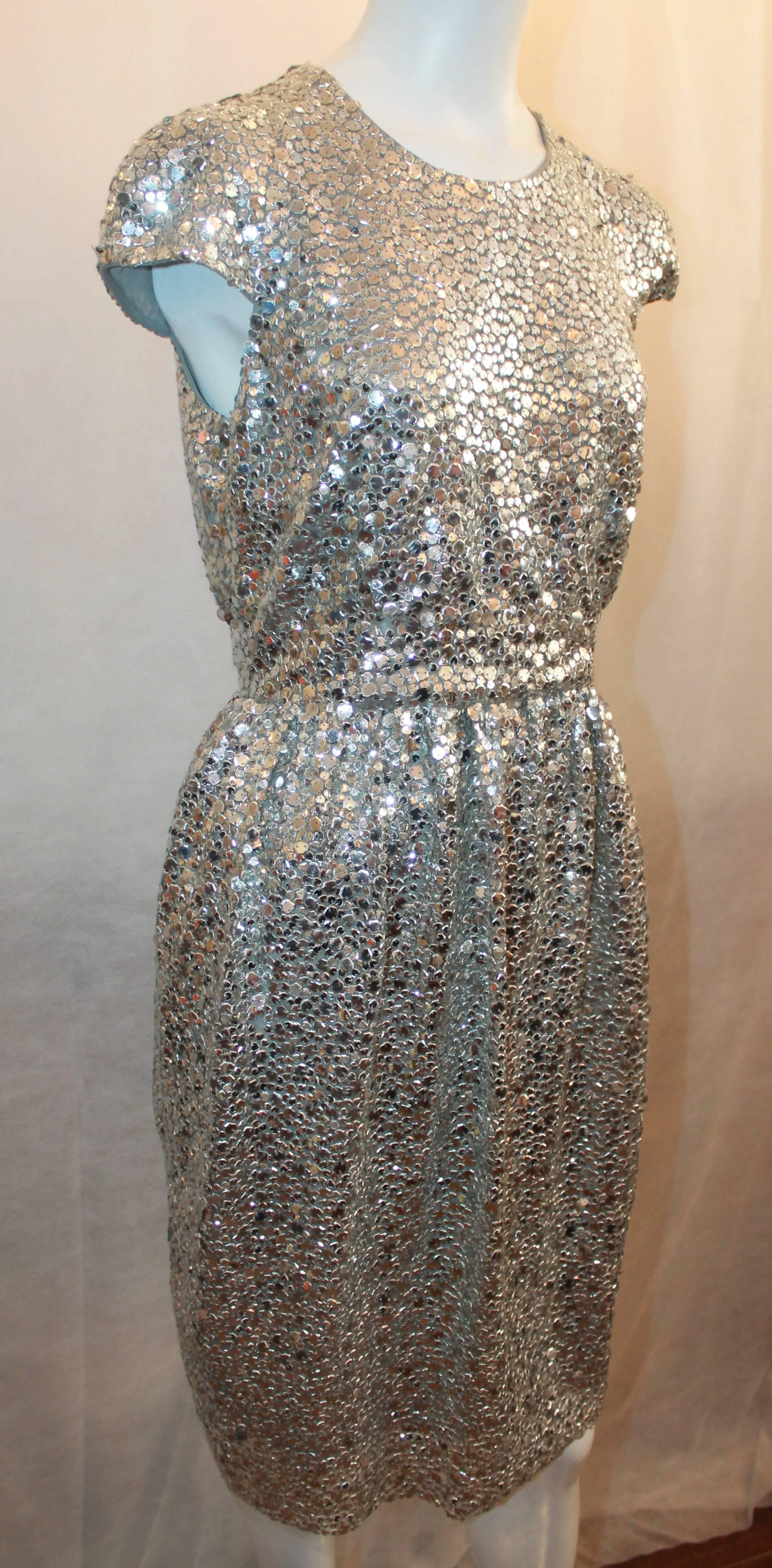 Naeem Khan Silver Silk & Mesh Sequin Short Sleeve Dress w/ Cinched Waist - 8.  This gorgeous dress is in very good condition with only some seuqins starting to come loose.  This Naeem Khan piece features edgy silver sequins throughout, a cinched