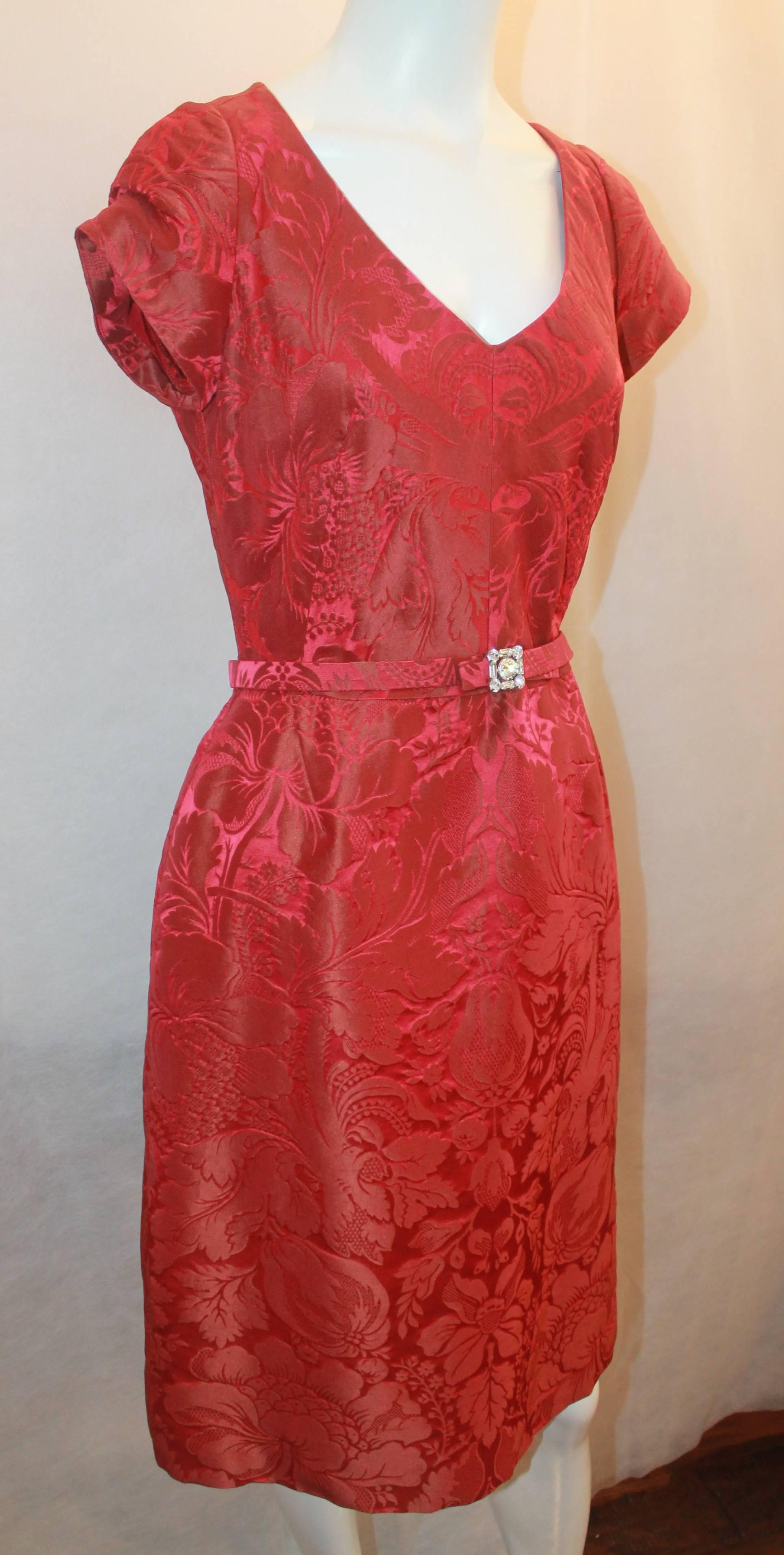 Oscar de la Renta Red Brocade Short Sleeve Dress  with Rhinestone Belt - 8. This dress is in excellent condition and fits amazingly. The zipper is in the back and the dress has a fitted bodice. It falls around the knees.

Measurements:
Bust-