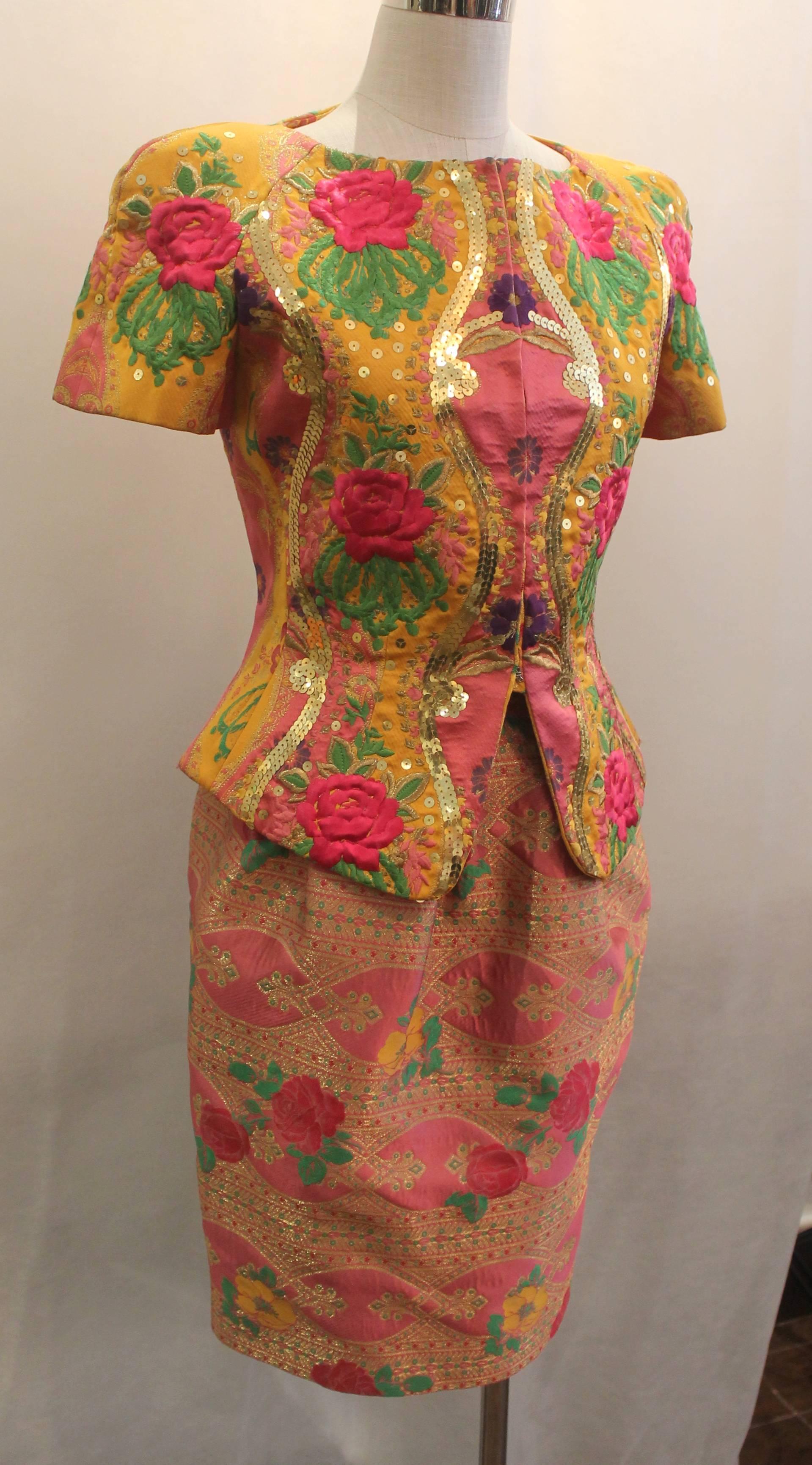 Christian LaCroix Vintage Multi-Color Silk Embroidered Floral Skirt Suit - 1990's. This skirt suit is in excellent condition and is a very unique piece. The suit has a pink background with gold & green designs and sequins on the top. The top is