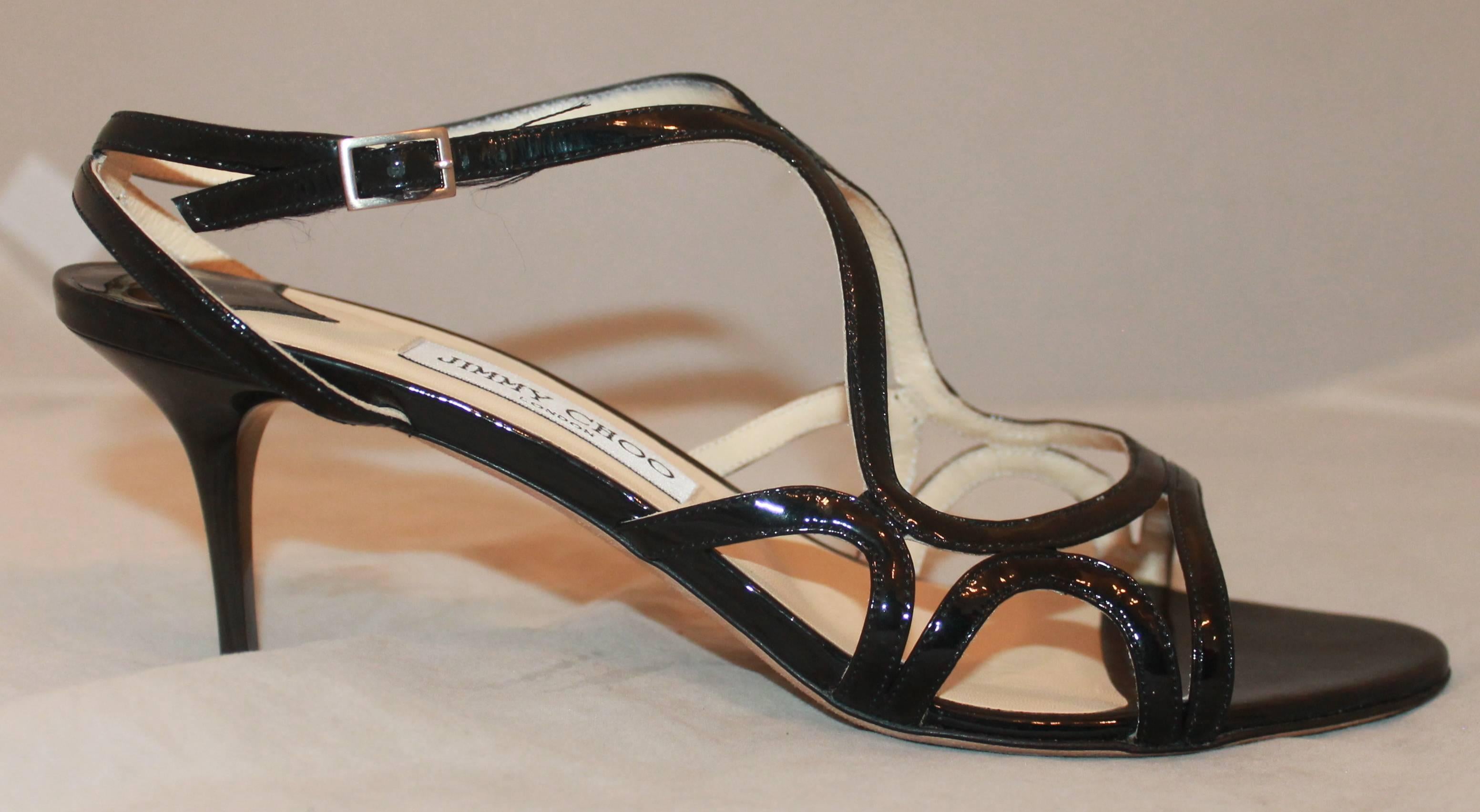Jimmy Choo Black Patent Strappy Sandal Heels - 40.  These adorable Jimmy Choo heels are in excellent condition with only minimal wear to the sole.  They feature a simple, but feminine black patent leather, and a strappy appearance with a double