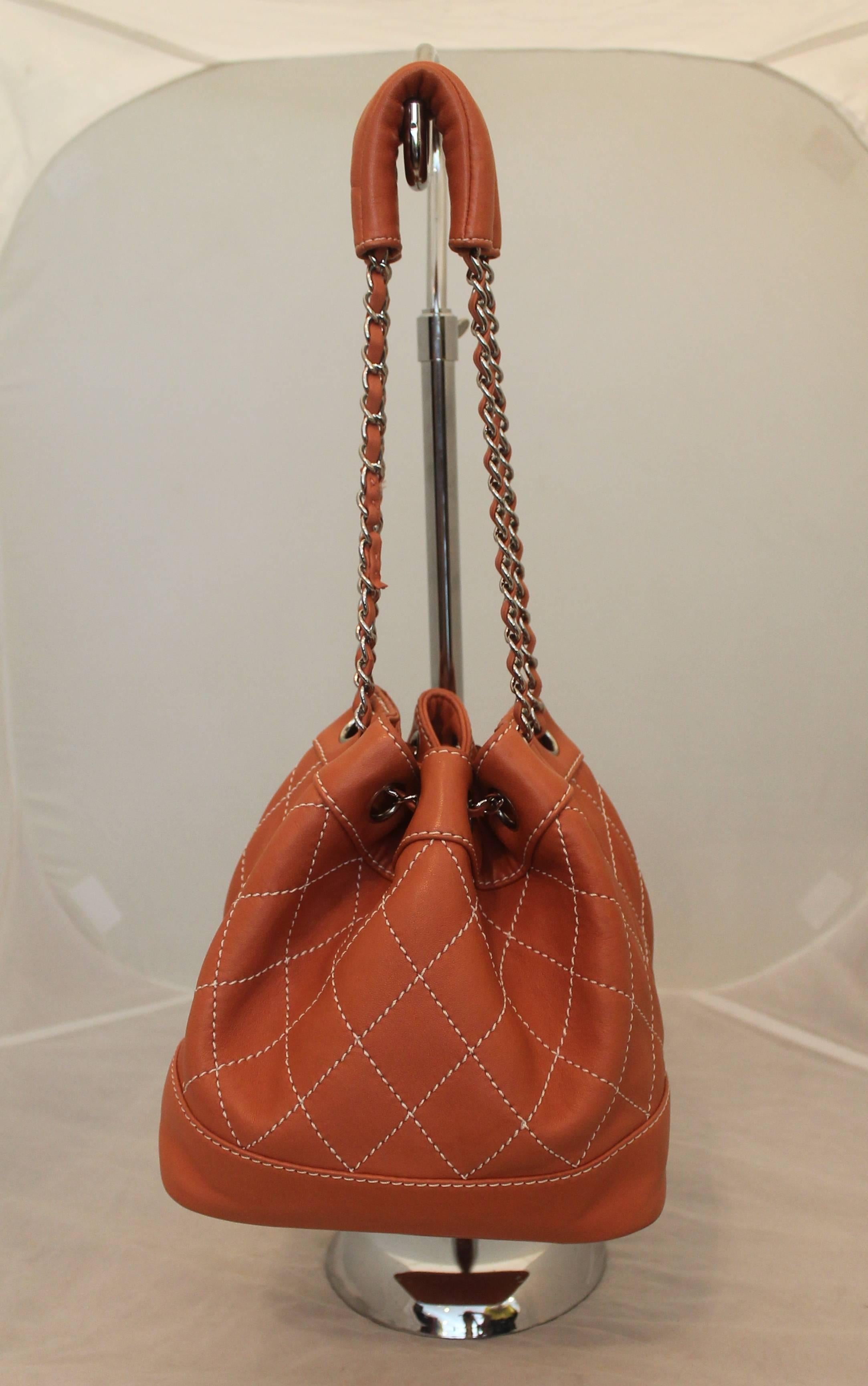 Chanel Coral Quilted Lambskin Bucket Bag - SHW - circa 2006. This bag is in good condition with some wear on the handle and one mark near the top shown in image 5. This bag is a great size and a perfect pop of color for the warm weather. It features