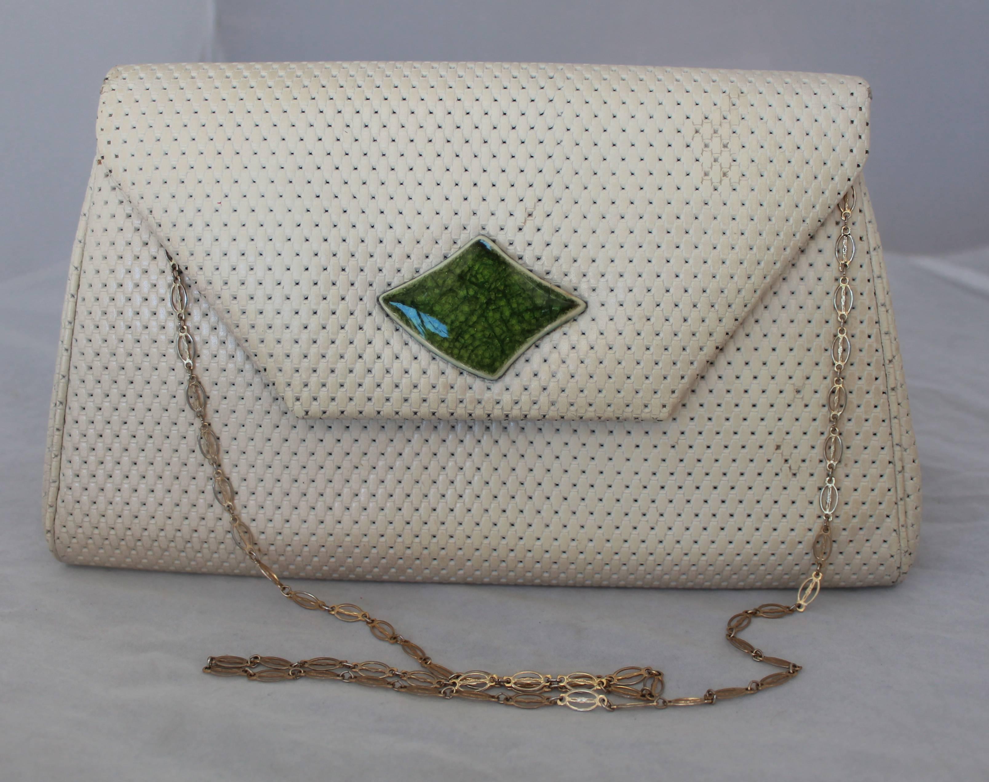 Paris Jacomo Ivory Perforated Leather Clutch with Green Stone - circa 1980's. This clutch is in good vintage condition with a couple areas having marks on the front and back (shown in images). The clutch is a fold-over style and features a tan