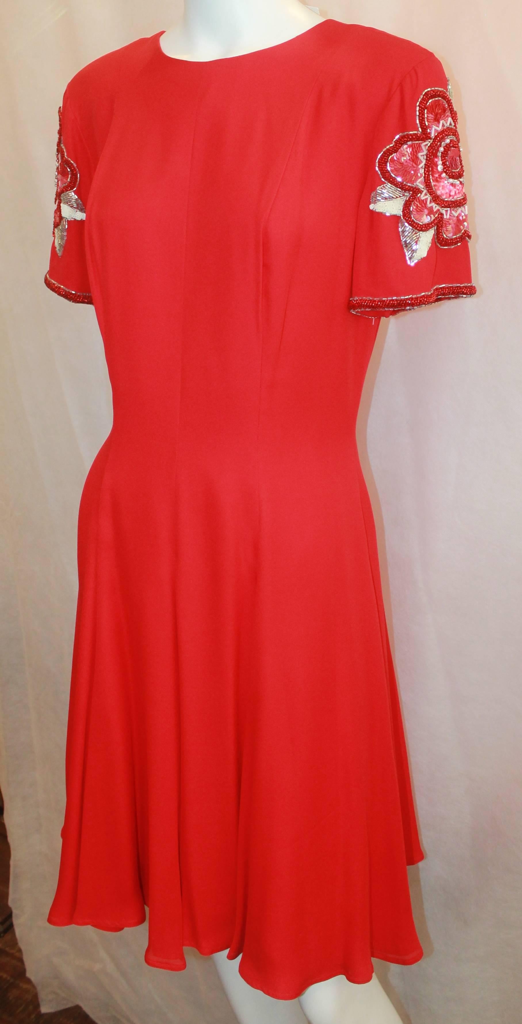 Bob Mackie Red Silk Short Sleeve Dress with Floral Beading - 6. This dress is in excellent condition and features a round neckline, pleats at the bottom, an intricate floral design on the shoulders, and a back zipper. 

Measurements:
Bust-
