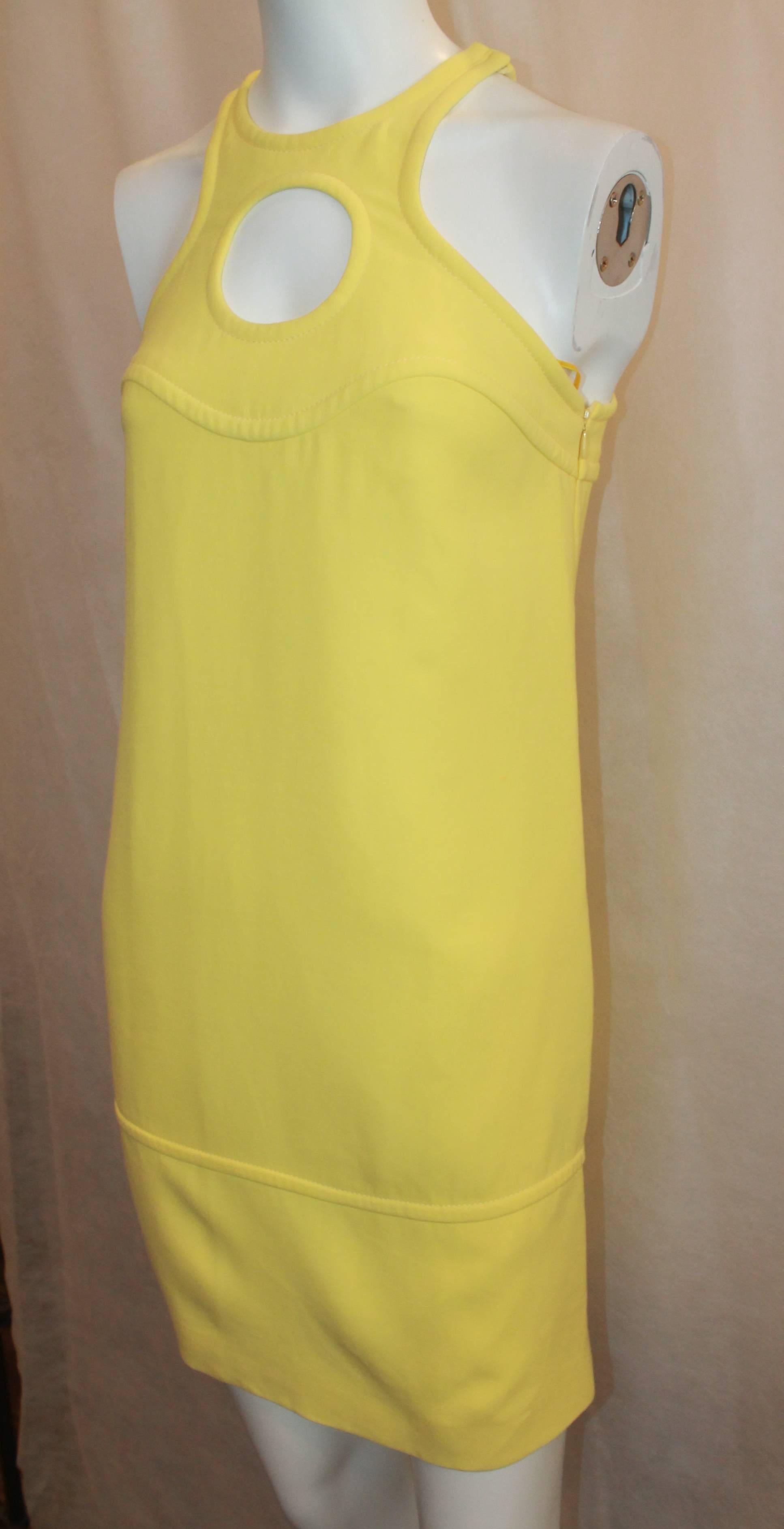 Emilio Pucci New Yellow Halter Dress with Keyhole - 38. This dress is in excellent condition and is perfect for spring and summer. This dress has a thick cotton fabric with 2 side pockets. It has one speck in the front which cannot be seen unless