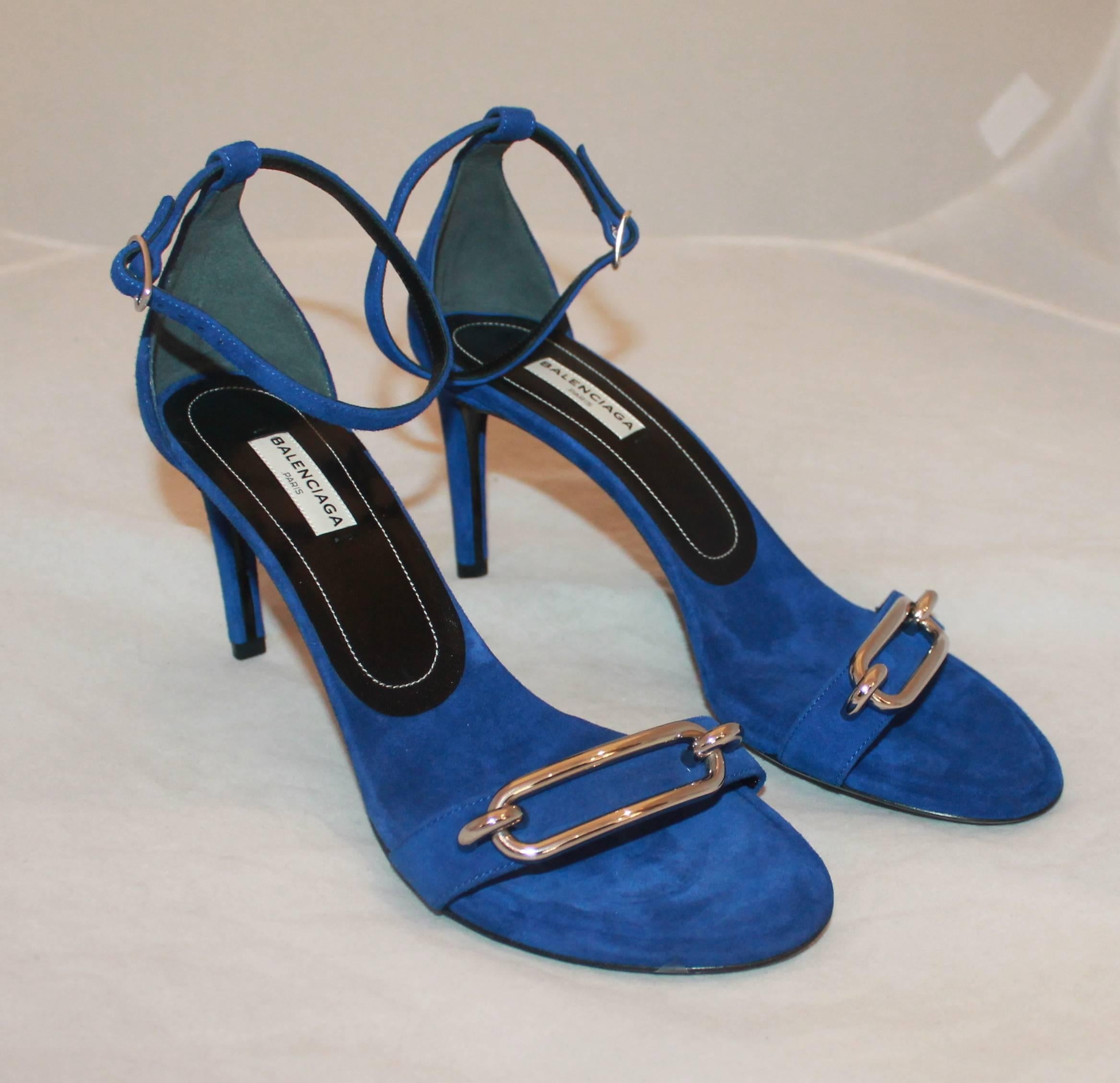 Balenciaga Electric Blue Suede Heels with Ankle Strap and Silver Buckle - 38.5.  These suede heels are an electric blue and have an ankle strap. On the front, they have a silver buckle. They are in new condition.

Measurements:
Heel- 3.25