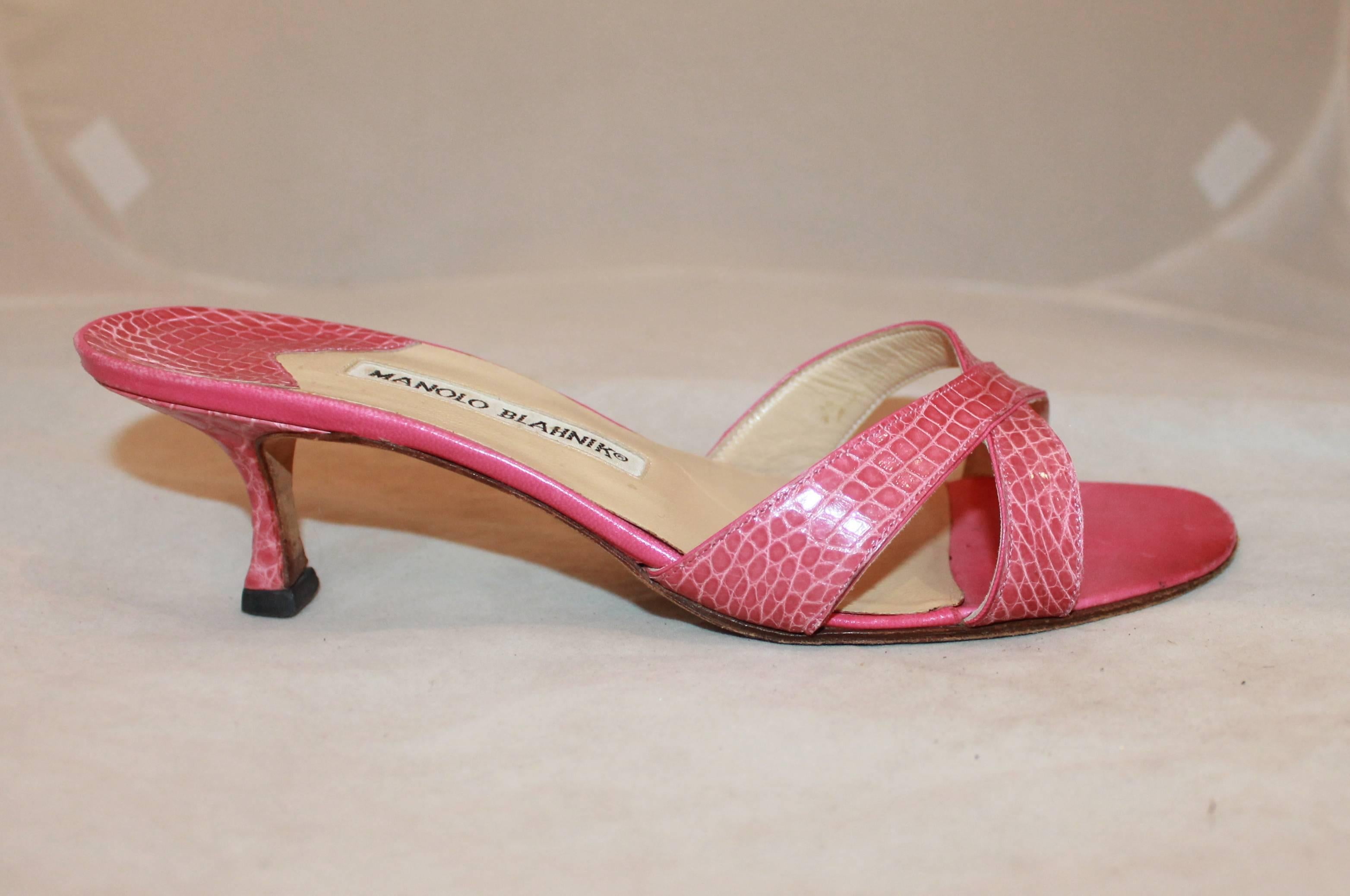 Manolo Blahnik Pink Crocodile Crisscross Slide with Heel - 38.5. These pink heels are slides with two straps crisscrossing on the top. They are in very good condition and show some wear on the bottom.

Measurements:
Heel- 2