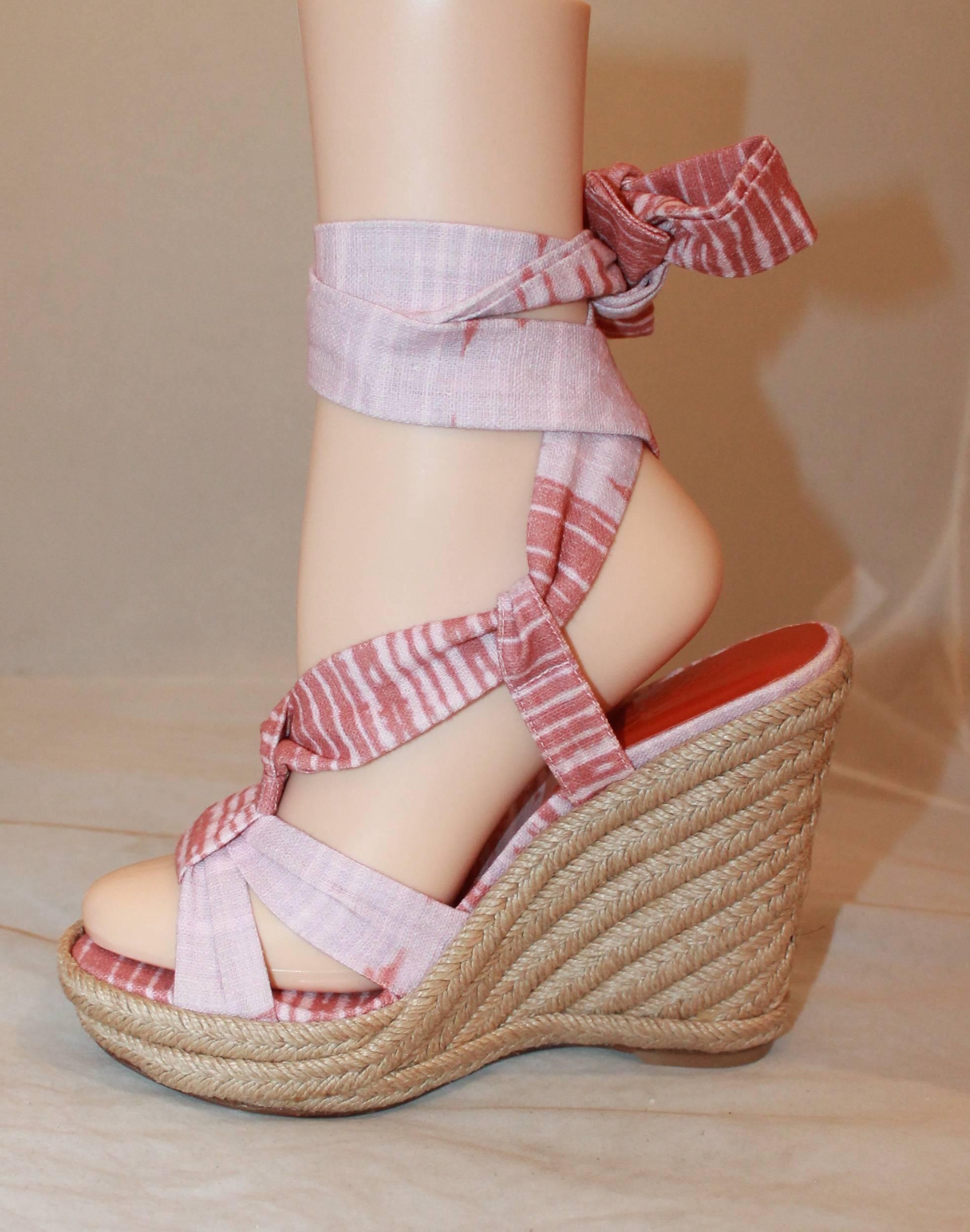 Stuart Weitzman Coral and Pink Canvas Printed Espadrille Tie-Up Wedges - 6.5. These printed wedges have a sole that was re-covered and feature pink and coral ribbon on the top of the shoe that tie up around the ankle. They are in new
