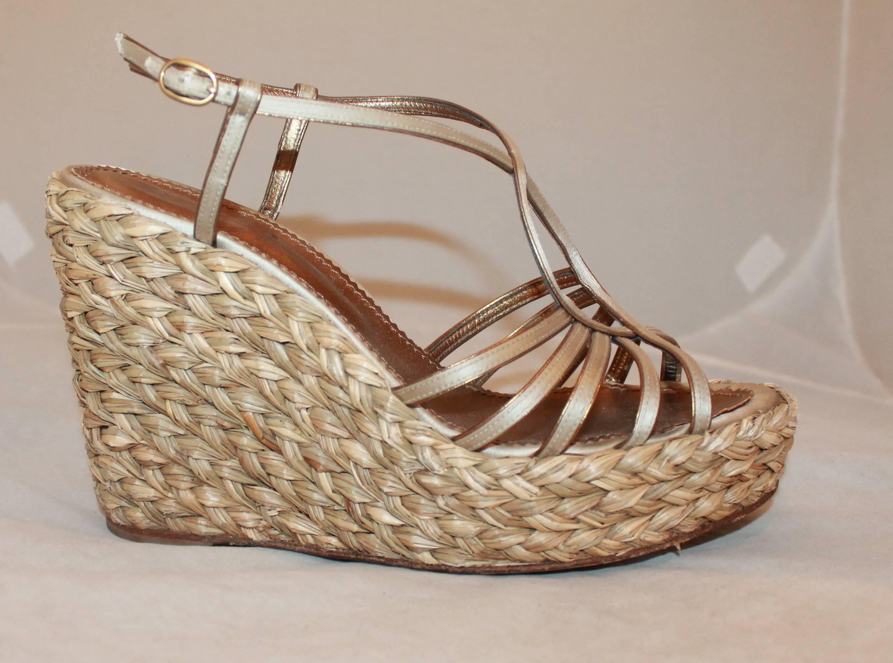 YSL Champagne Colored Satin Strapped Thick Straw Wedge - 41. These thick, straw, wedges have metallic champagne colored satin straps interweaving on the top of the shoes. They are in good condition and show some wear on the straw wedge and there is