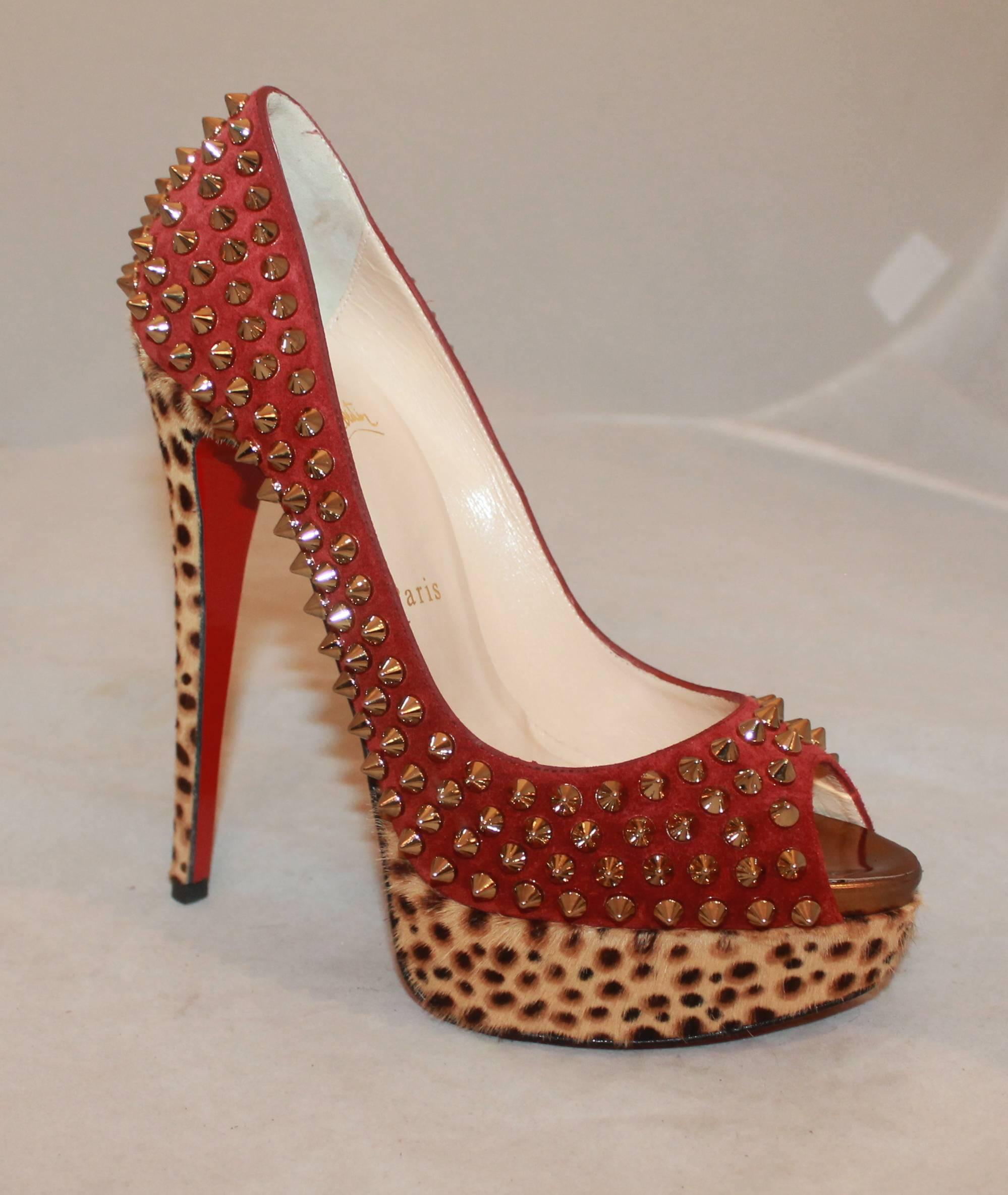 Louboutin Brick Red, Spike, and Leopard Print Suede/Pony Hair Platform Heels-38. These exotic heels feature a peep-toe, gold-colored spikes on top of brick-colored suede, leopard-print pony hair, and a platform. They are in excellent condition and