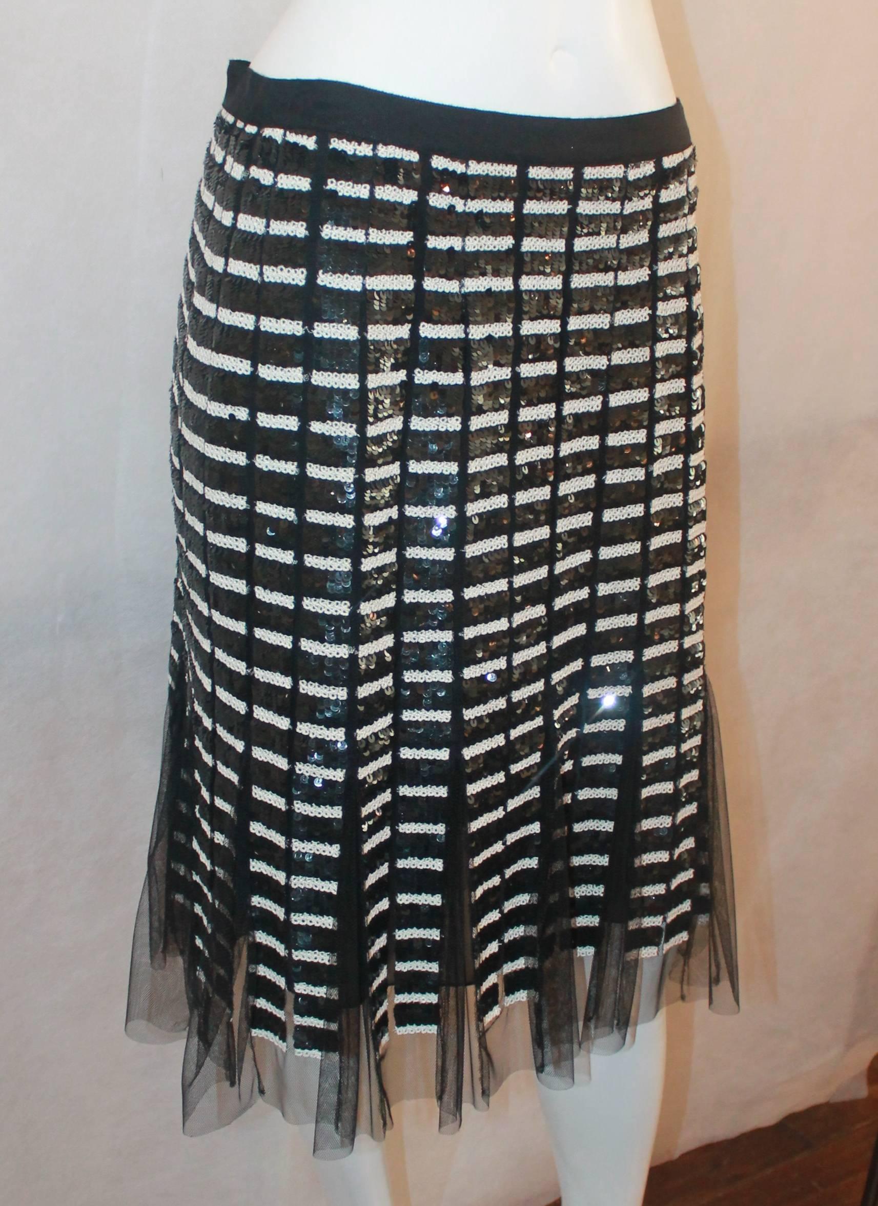 Oscar de la Renta Black & Ivory Sequin and Mesh Pleated Skirt - 10. This skirt is in excellent condition and is covered in sequins that are in a striped pattern. The bottom of the piece is pleated and the mesh sticks out. The waist also has a