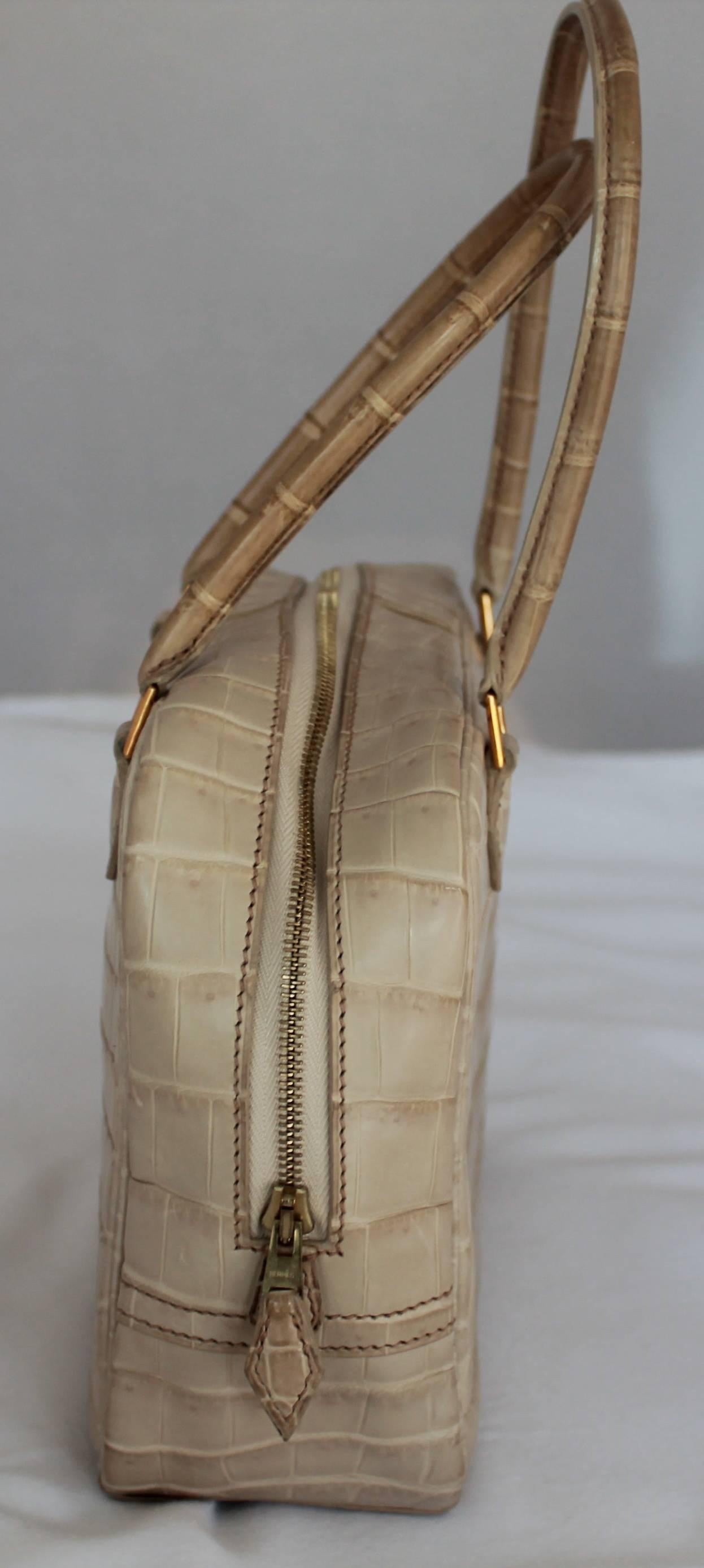 Hermes Beige Crocodile 20cm Plume Handbag - GHW - 2003  This handbag has gold feet and gold hardware. Both handles have slight discoloration due to wear. Comes with Duster. 
Measurements:
Width: 20 cm
Height: 15.25 cm
Depth: 8.25 cm
Handle