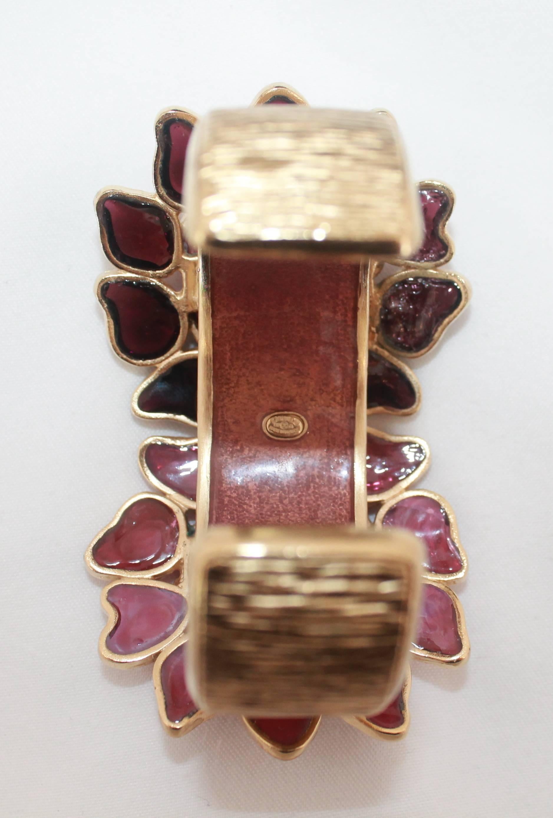 Chanel Purple/Pink Gripoix Gold Byzantine Paris-Dubai Cuff-2015  This beautiful collectible cuff has a textured feel on the gold part of the cuff. The gold cc logo is on the front of one of the two floral gripoix pieces. This cuff comes with the