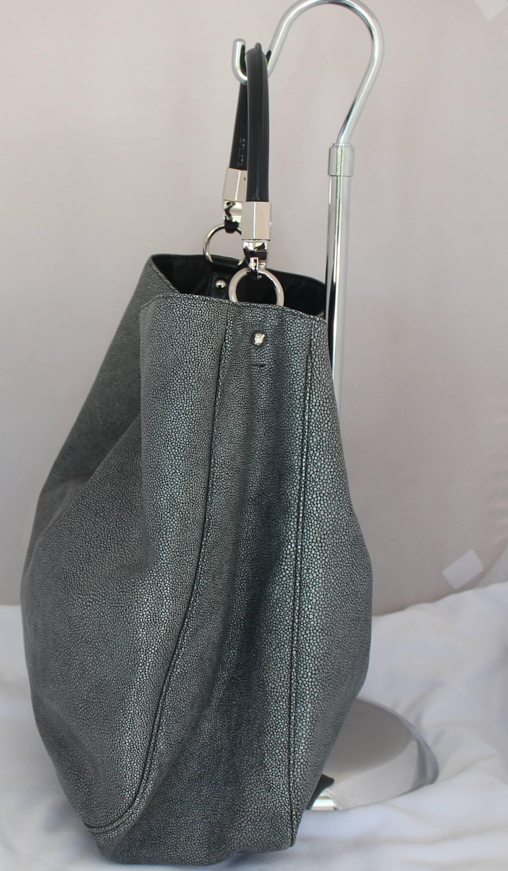 YSL Grey Stingray Embossed Leather Roady Shoulder Bag - SHW. This slouchy bag is in excellent condition and features a black leather handle, very roomy inside, 2 interor cell pockets and 1 interior zip pocket.

Measurements:
Height- 15