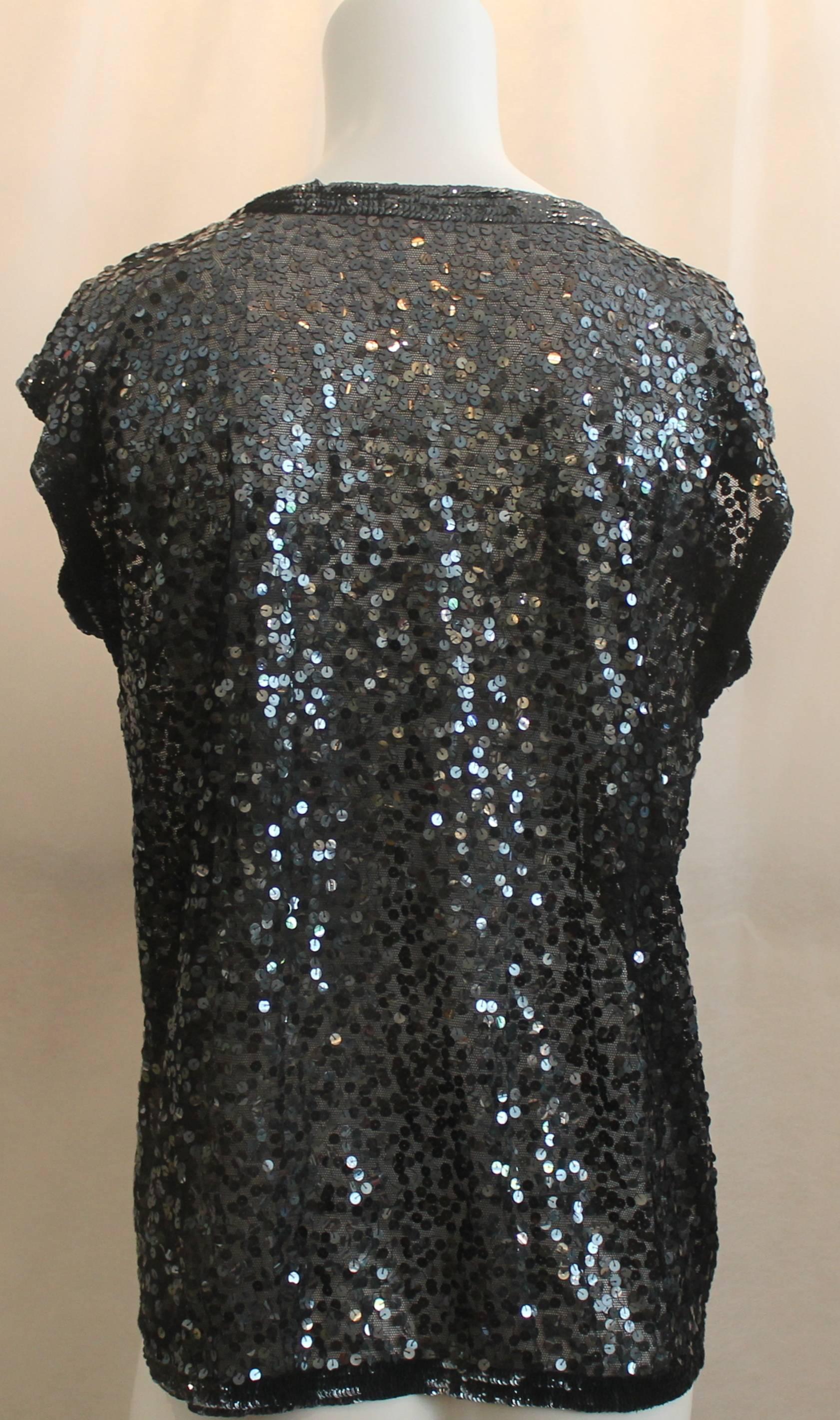 Zoran Black Sequin Short Sleeve Sweater - Medium. This sequined short sleeve sweater is completely covered in sequins. The trim is also sequined but the sequins are closer together. The fabric under the sequins is net-like and there is no closure.