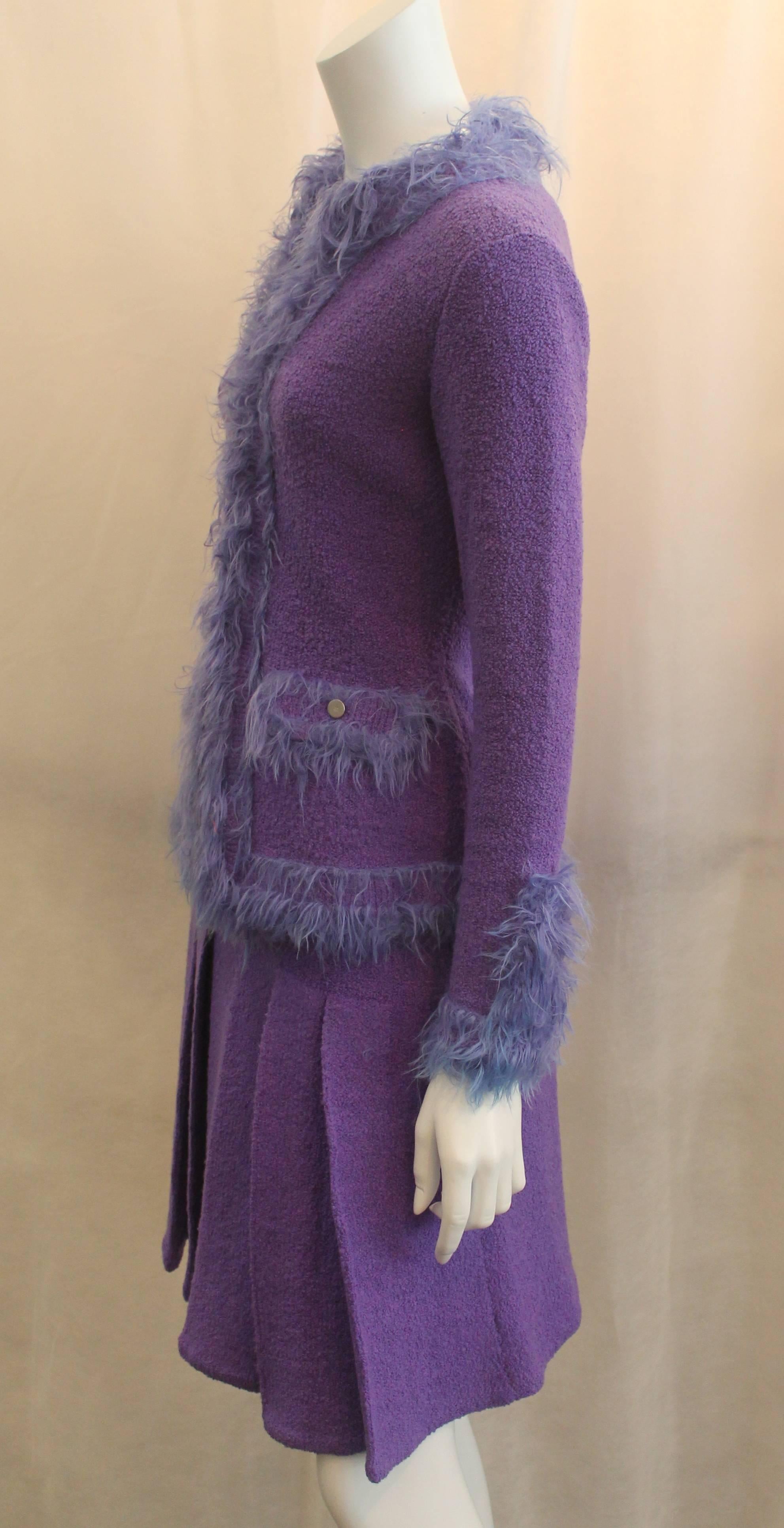 Chanel Purple Wool Skirt Suit with Faux Fur Trim - 38 - circa 99P
14. This set is in excellent vintage condition with minor wear. The jacket features 2 fake pockets with buttons and a long fur trim. The skirt has big pleats on the front