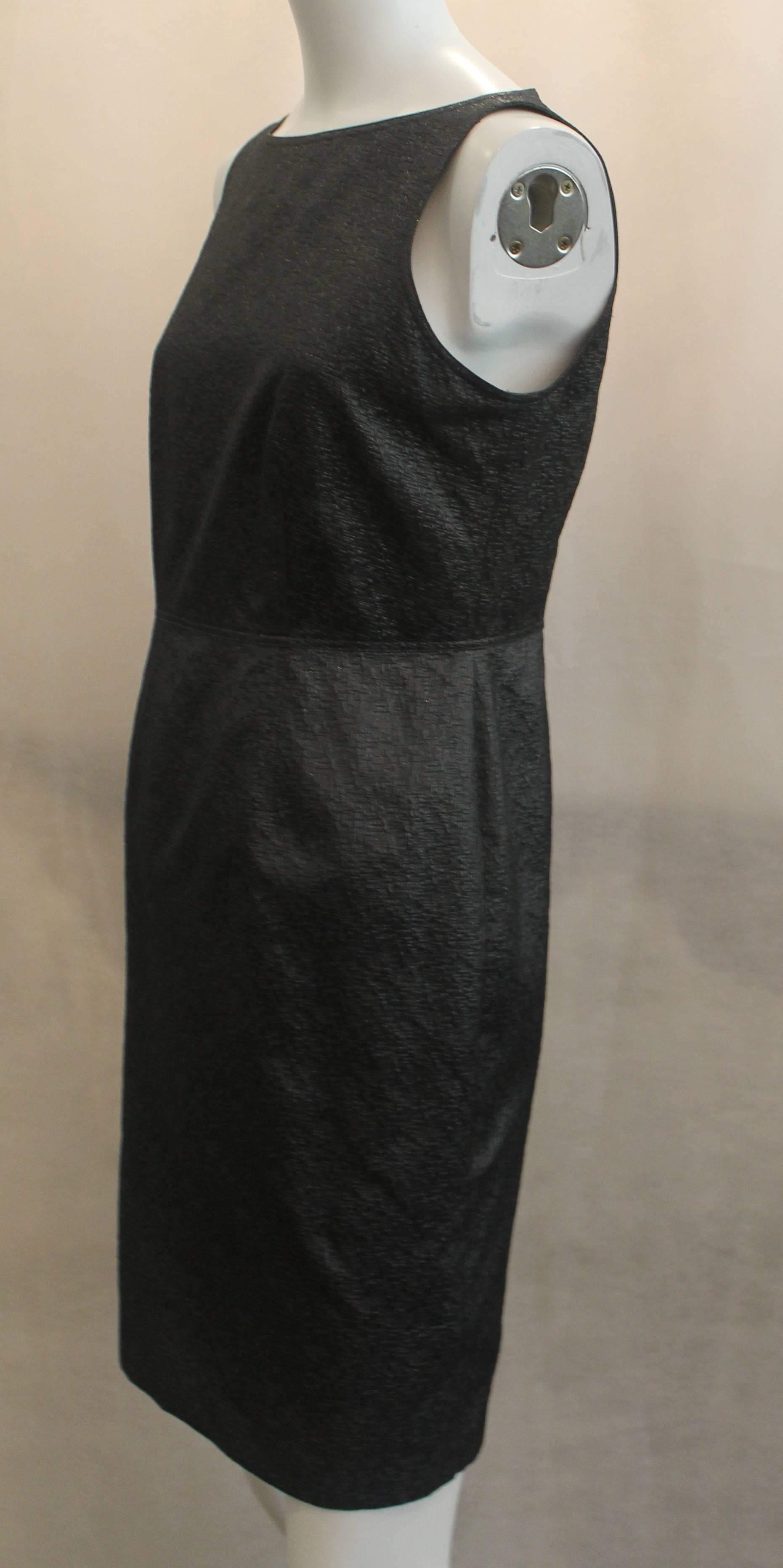 Burberry Sleeveless Fitted Metallic Charcoal Colored Polyester Brocade Dress - 6. This beautiful dress is a metallic charcoal color. It is made of polyester brocade. This dress features a sleeveless, fitted design with a slit in the back.
It is in
