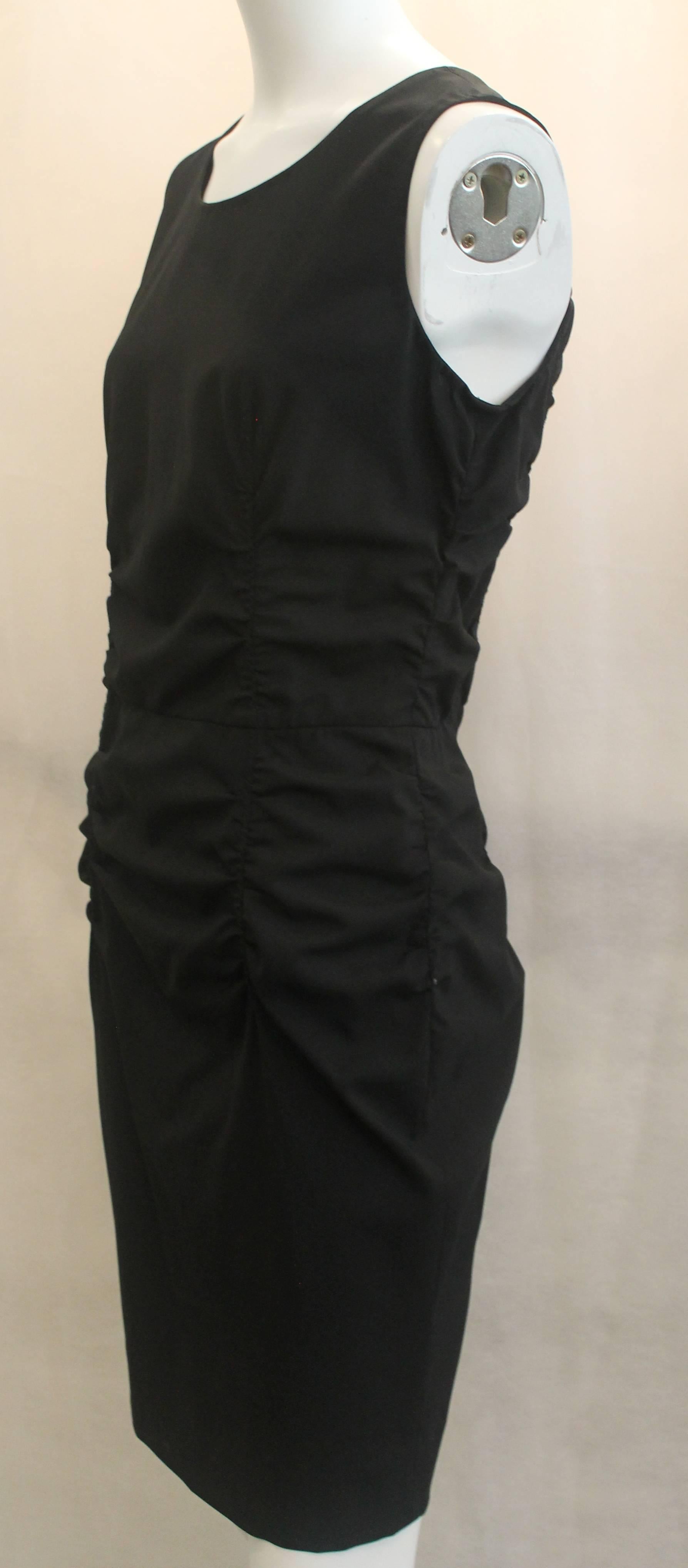 Prada Black Silk Blend Ruched Sleeveless Dress - 44. This fitted sleeveless dress is black with ruching on the sides and back. It is in good condition with a small white stain on its side and some marks on the bottom. There is a small beige stain by