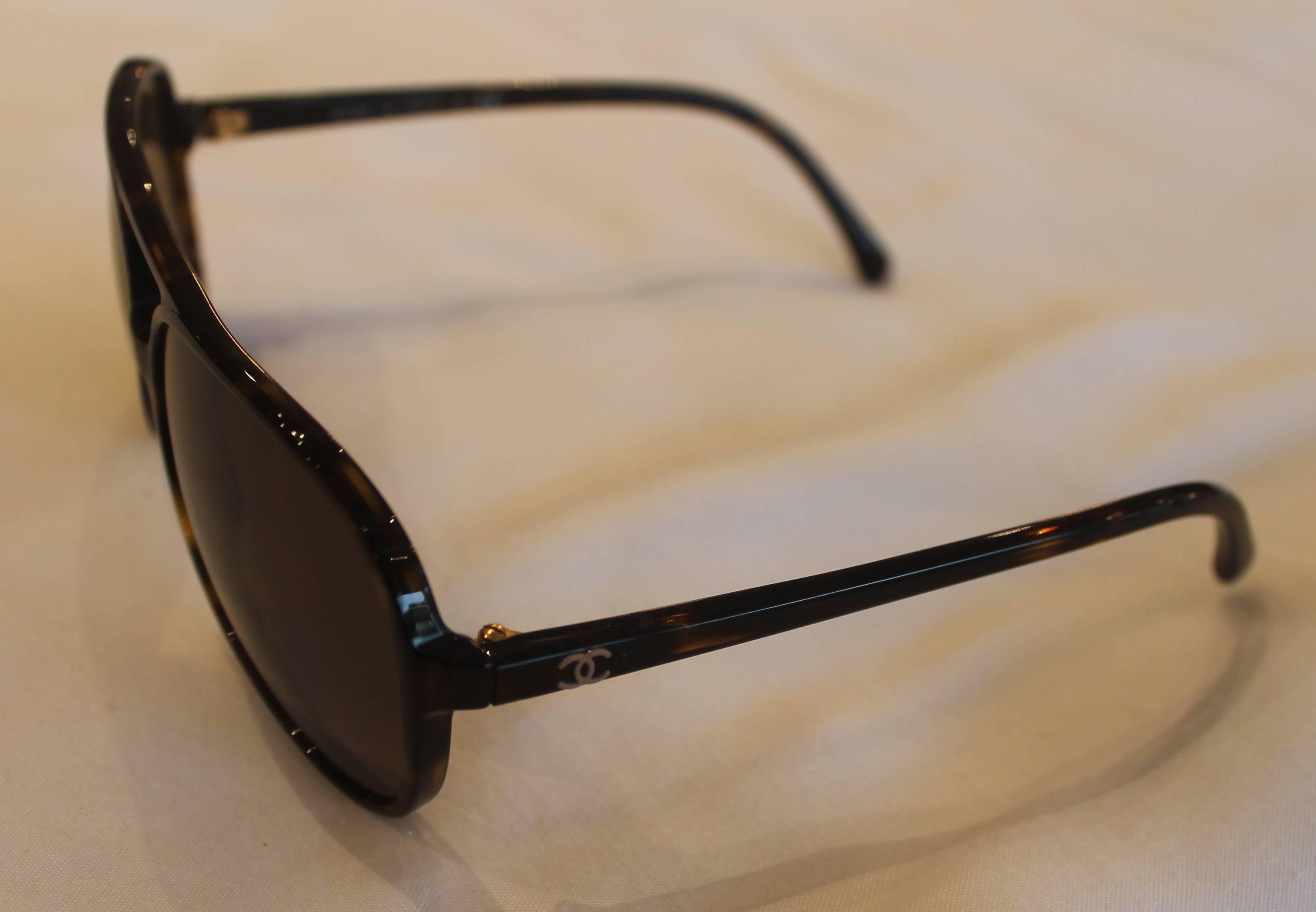 black sunglasses with gold v on side