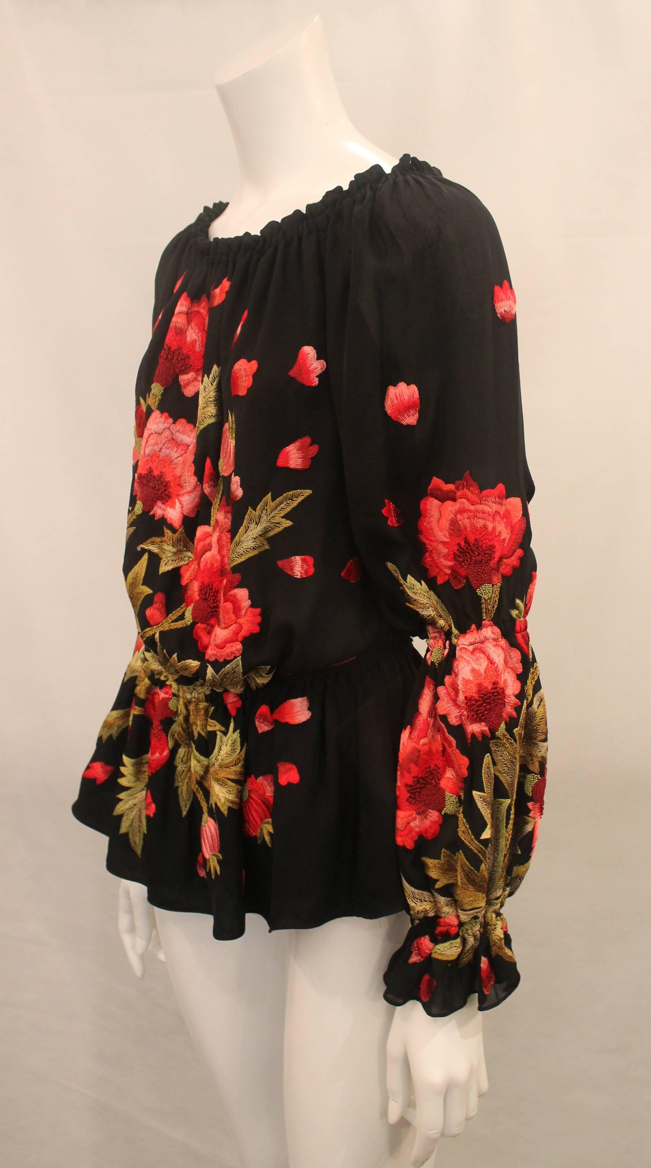 Naeem Khan Black Silk Peasant Blouse with Floral Embroidery - M. This trendy long sleeve blouse is in excellent condition with light wear. It features a floral embroidery with pink and red stitching and an elastic band at the neckline, hips and