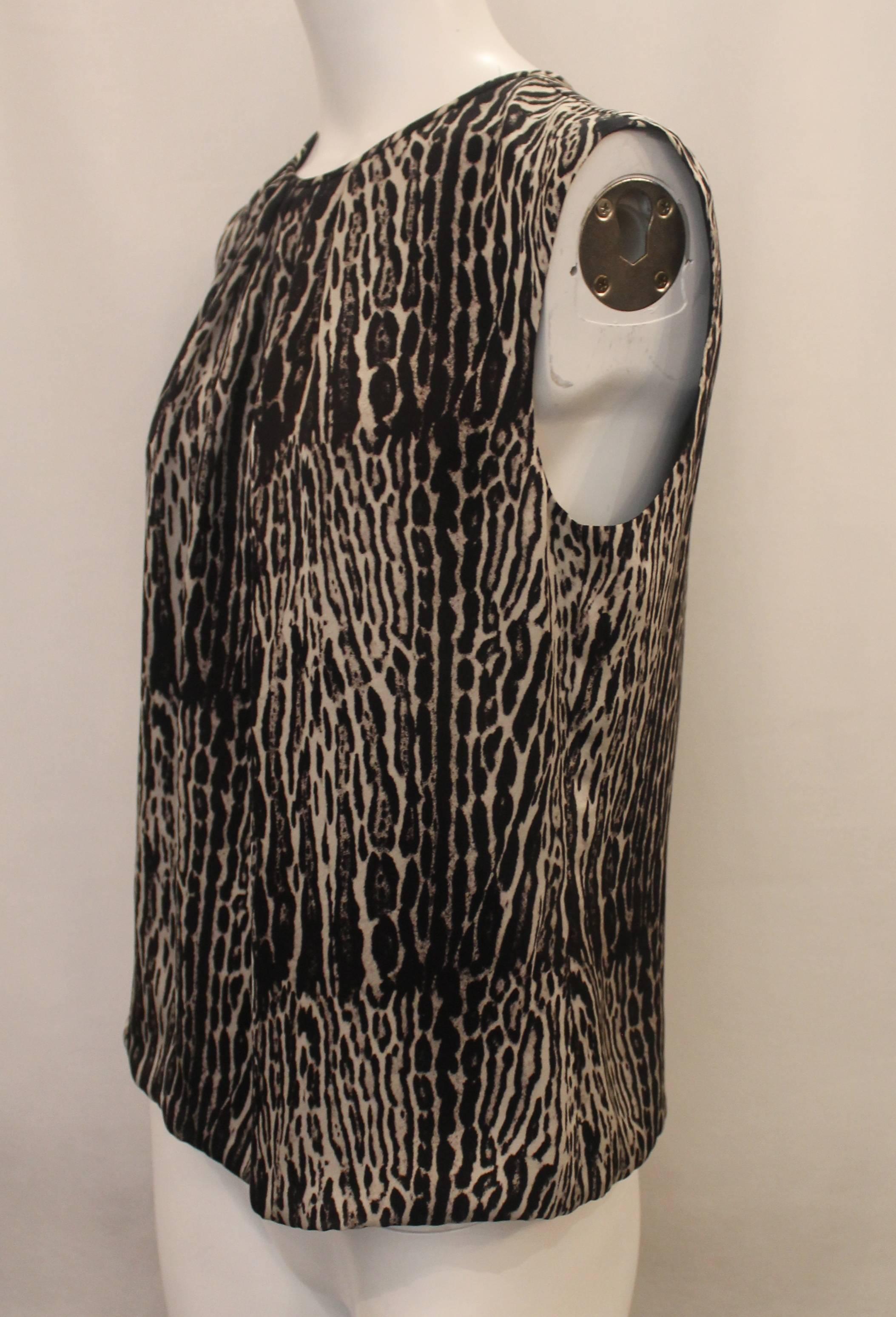 Giambattista Valli Grey & Black Silk Animal Print Top - 44. This blouse is in excellent condition with very light wear. This flowy top features slight pleats at the neckline and a back zipper.

Measurements:
Bust- 41