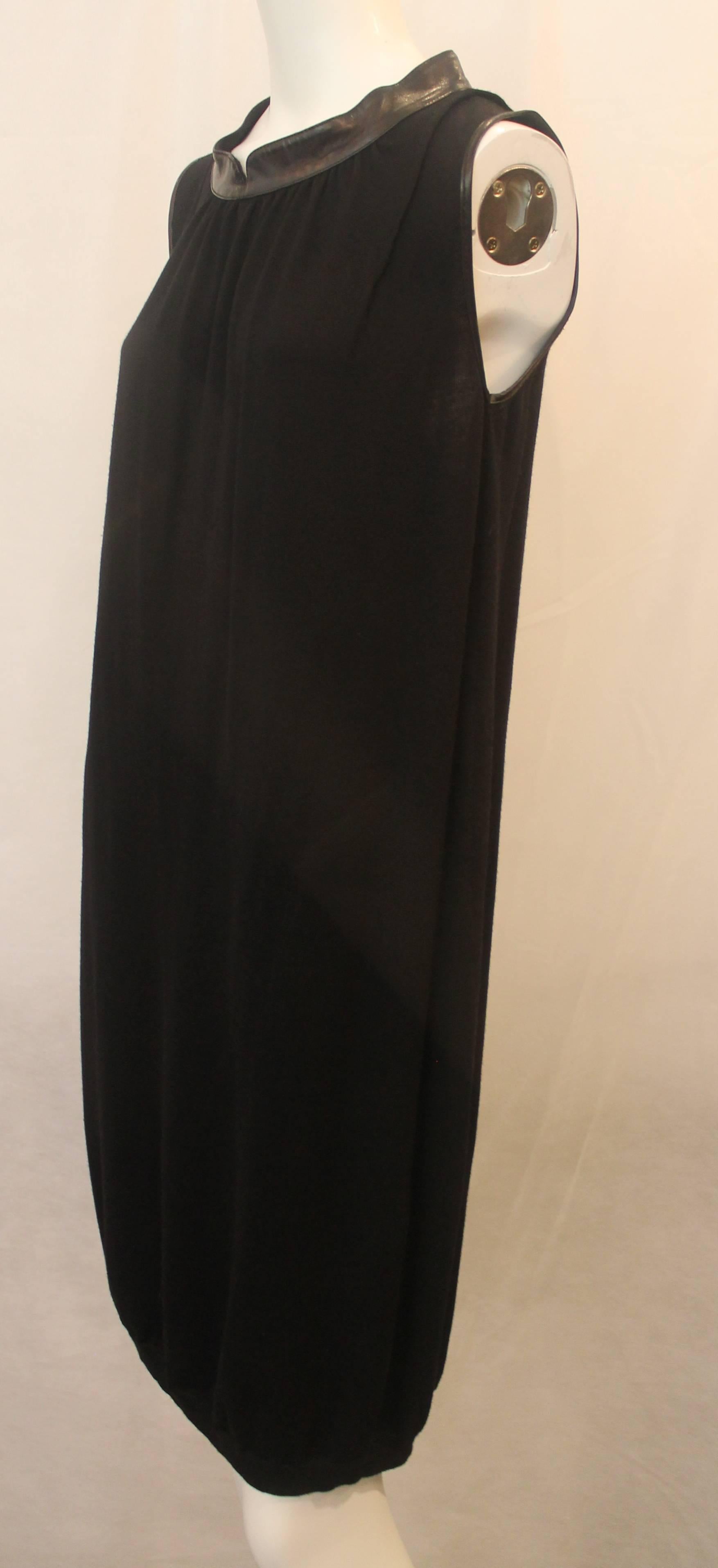 Yves Saint Laurent Black Wool Sleeveless Knit Shift Dress with Leather Collar -M. This beautiful sleeveless dress is a trendy twist on a classic look! It is black knitted wool with leather trim around the arm holes and neck. It is in good condition