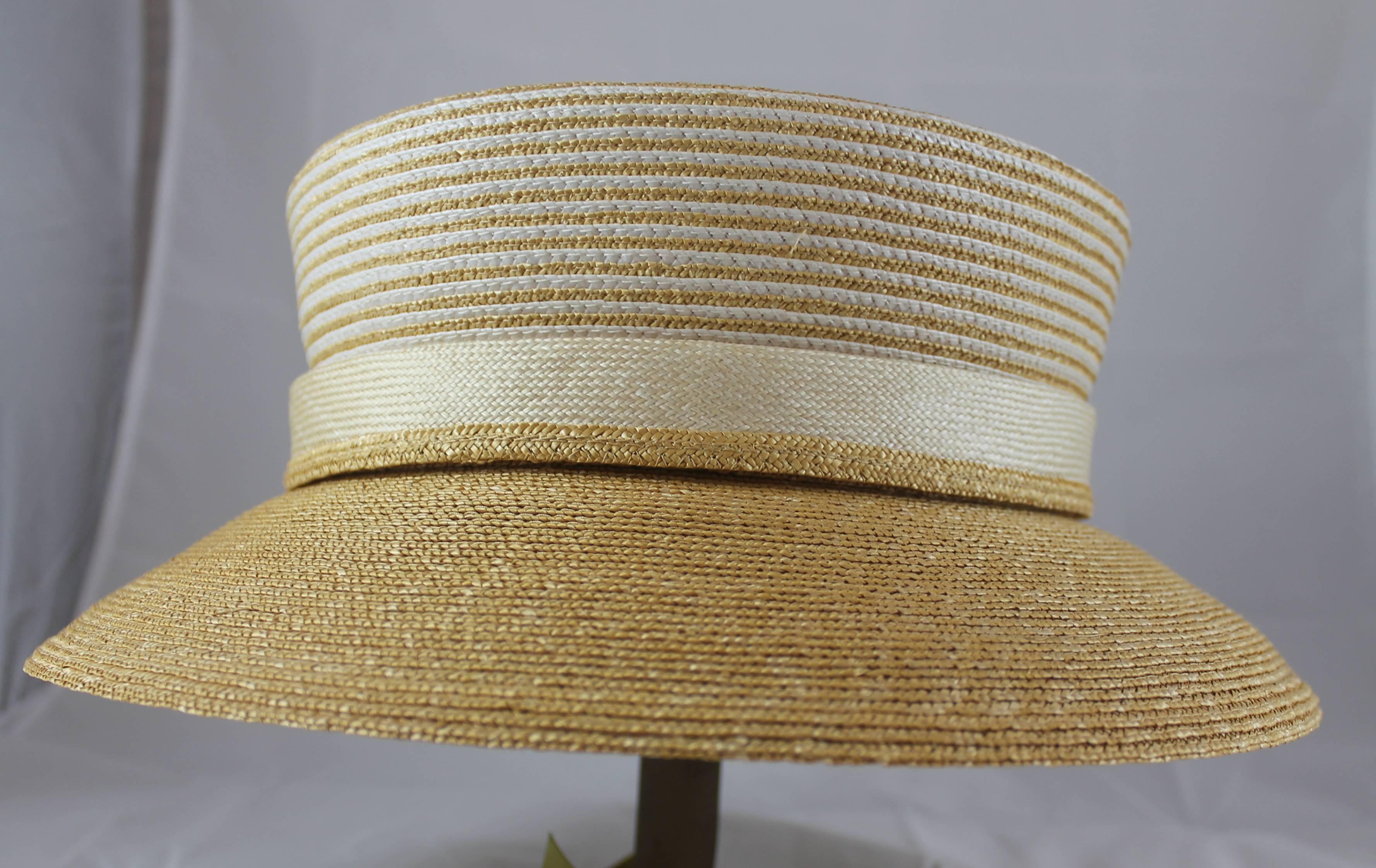 Suzanne Custom Millinery Tan Straw Hat with Thin Ivory Stripes. This hat is a straw hat with thin ivory stripes on the top. There is a down turned, tan, brim. It is in excellent condition with one small stain on the inside that is not