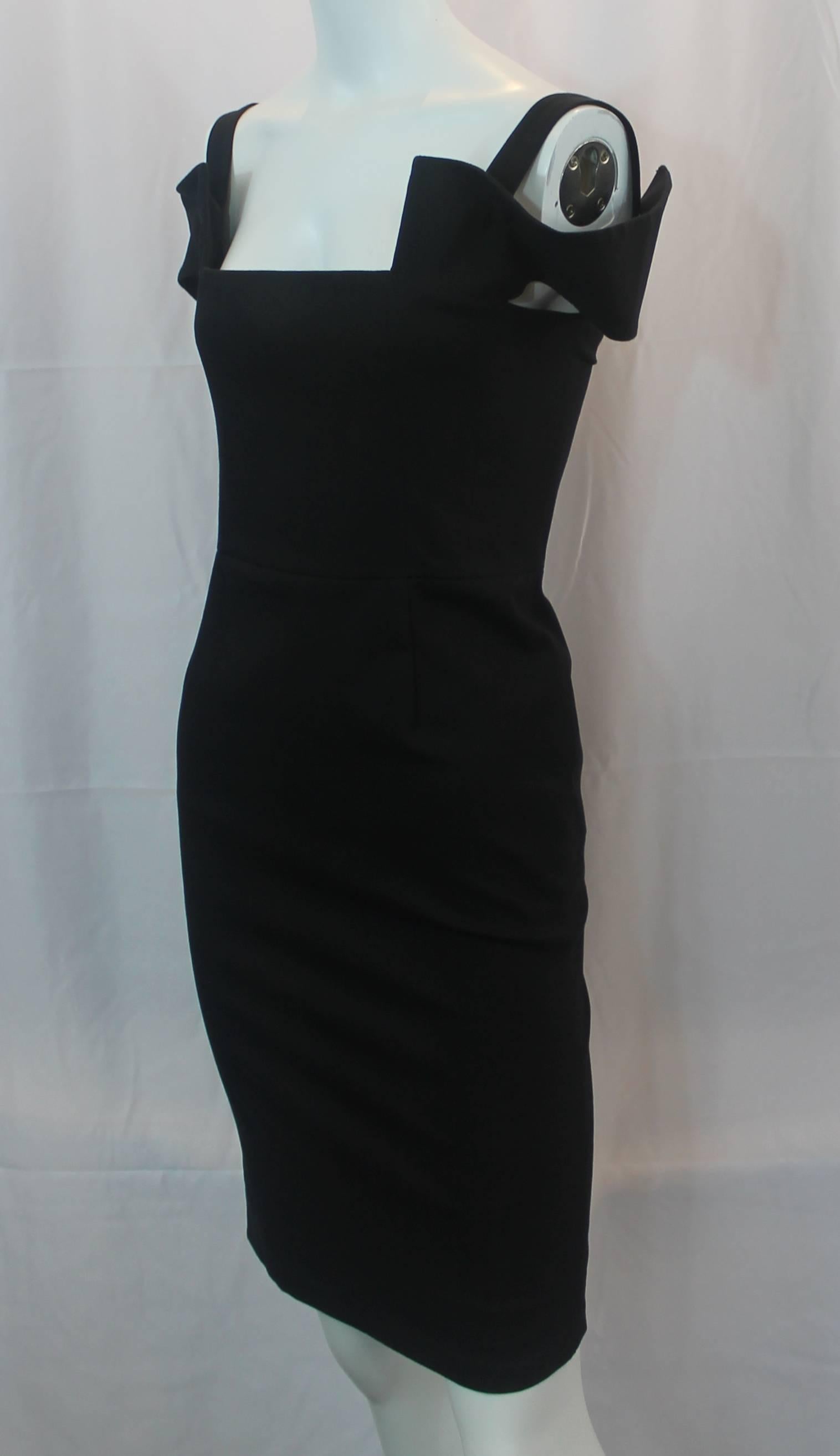 Fendi Black Cotton Blend Tapered Dress with Cutouts - 40. This chic tapered dress has a straight neckline and cutouts on the sleeves. On the back, there is a zipper and a cutout look. This dress is in good condition with faint stains on the dress