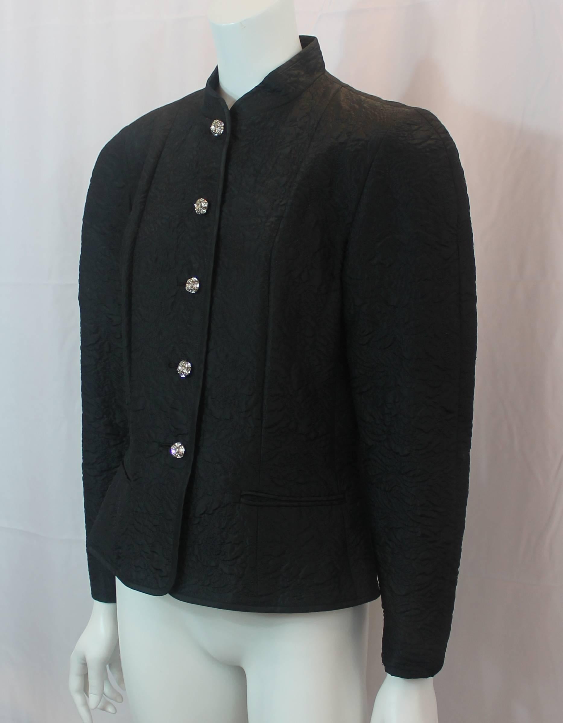 The 80's is back with this Guy Laroche Vintage Black Silk Blend Evening Jacket - 40 - circa 1980s. This vintage evening jacket has a quilted design, 2 sealed front pockets, rhinestone buttons, and shoulder pads. It is in excellent vintage condition
