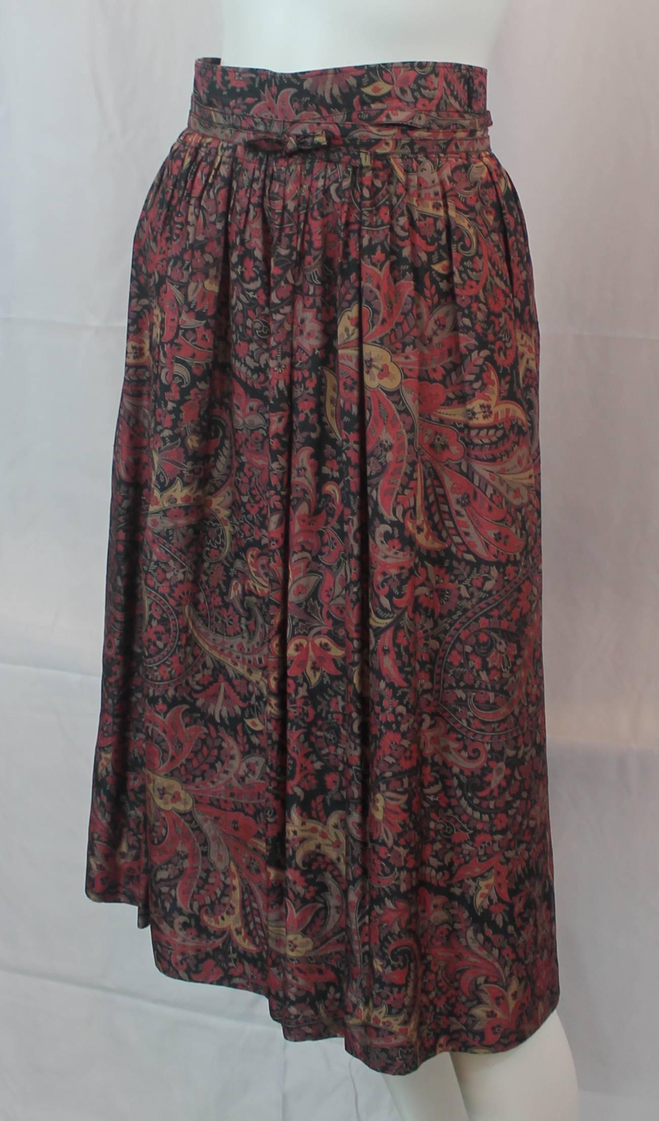 Bogner Vintage Multi-Colored Floral Print Silk Wrap Skirt - 38 - 1990's. This floral print silk skirt has a thin belt that is used to wrap the skirt around the body. The skirt is multi-colored with shades of reds, earth tones, and black. It is in