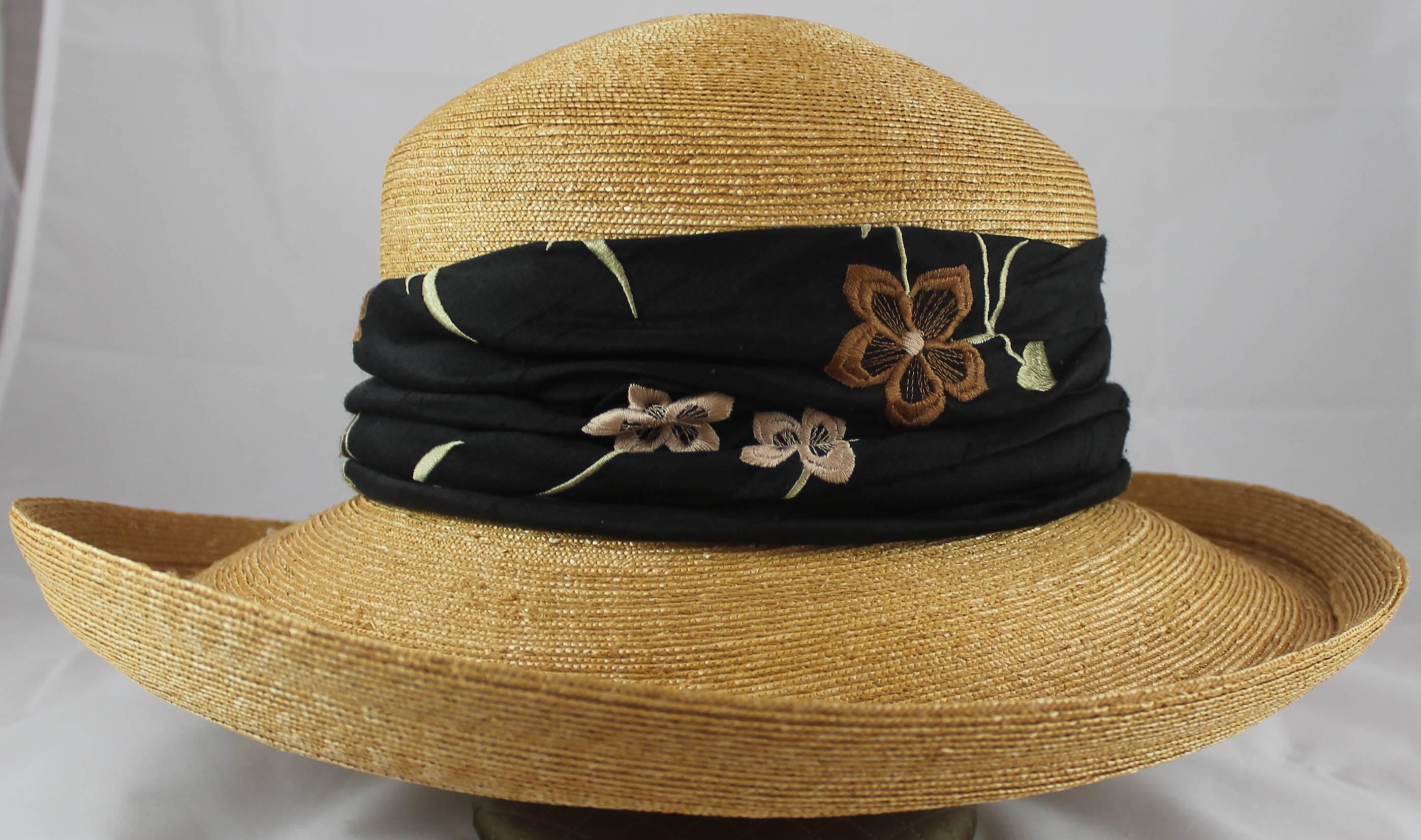 Suzanne Couture Millinery Tan Straw Hat with Black Floral Ribbon. This hat is in excellent condition and is perfect for summer time! The black ribbon has a stitched, floral design in earth tones. 

Measurements:
Brim- approximately