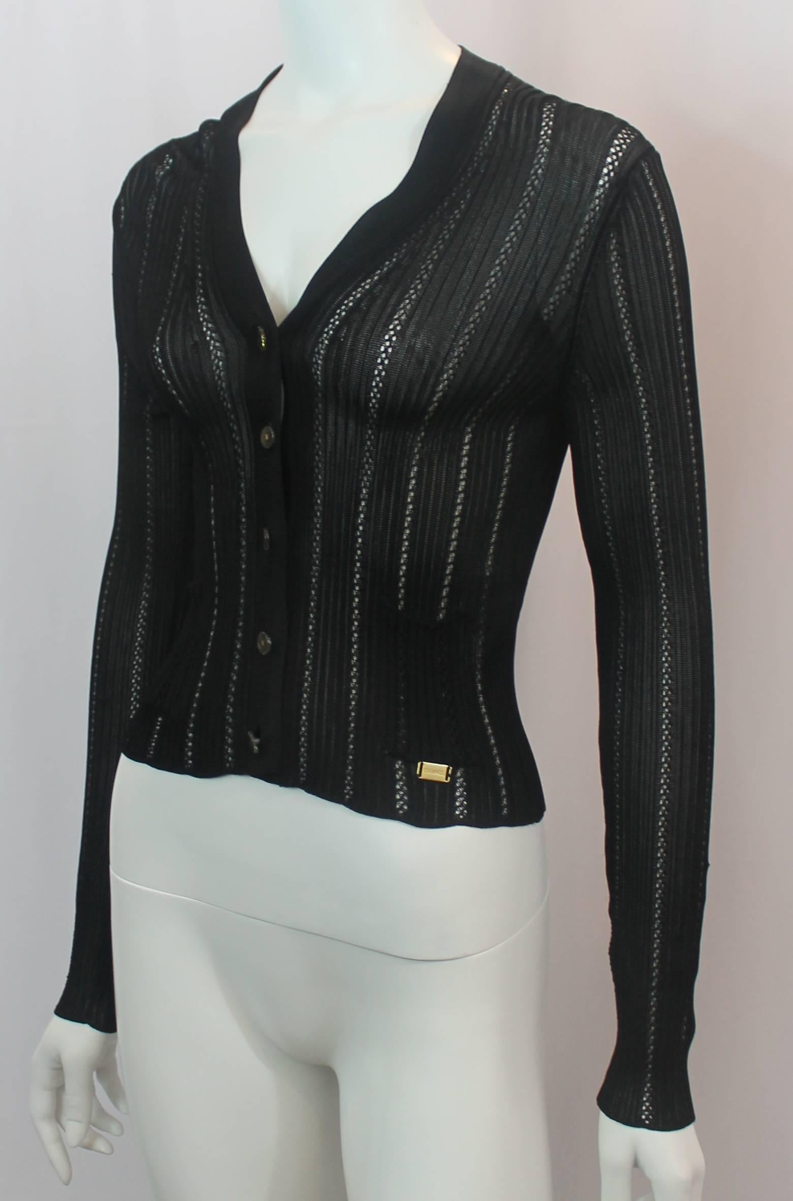 Chanel Black Silk Knit Long Sleeve V-Neck Light Cardigan - 36 - 1990's. This vintage silk knit cardigan is lightweight, long sleeve and has a v-neckline. There are 2 small front pockets and a gold Chanel logo plaque. The buttons are clear Lucite