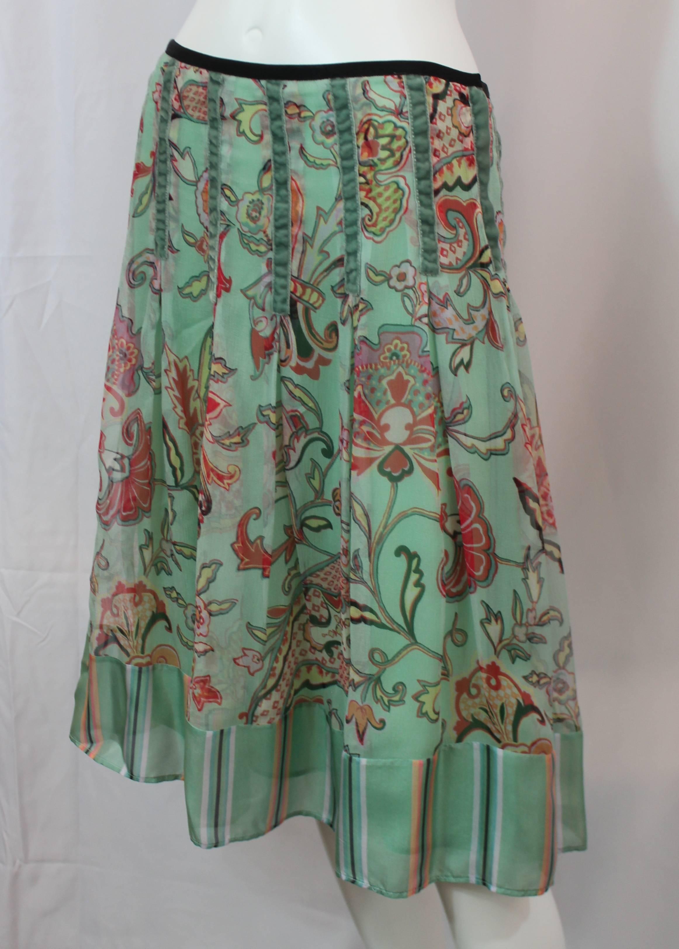 Etro Seafoam Silk Chiffon Paisley Print Skirt with Striped Silk Bottom - 42. This seafoam skirt has a multi-colored paisley print and a striped silk bottom. There is velvet detailing all along the middle and a black ribbon along the waist. There is