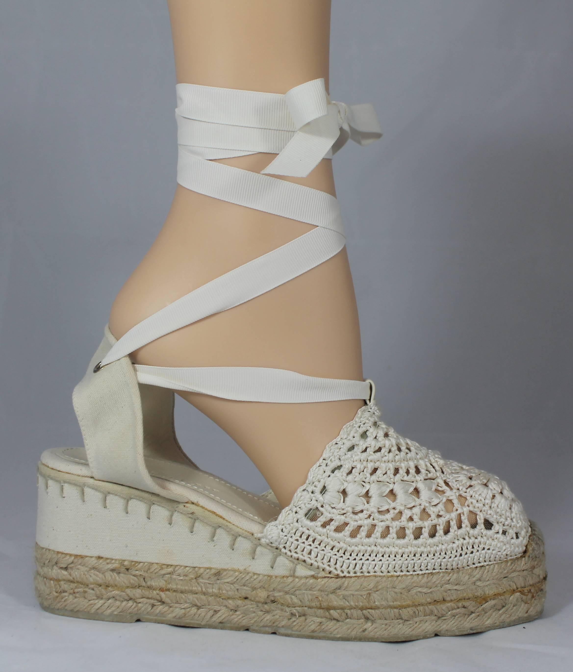 Ralph Lauren Collection White Crocheted Tie Up Espadrille Wedges - 6.5. These adorable wedges are white with an espadrille platform. They also have white ribbon that ties up around the leg. They are in good condition with minor discoloration and