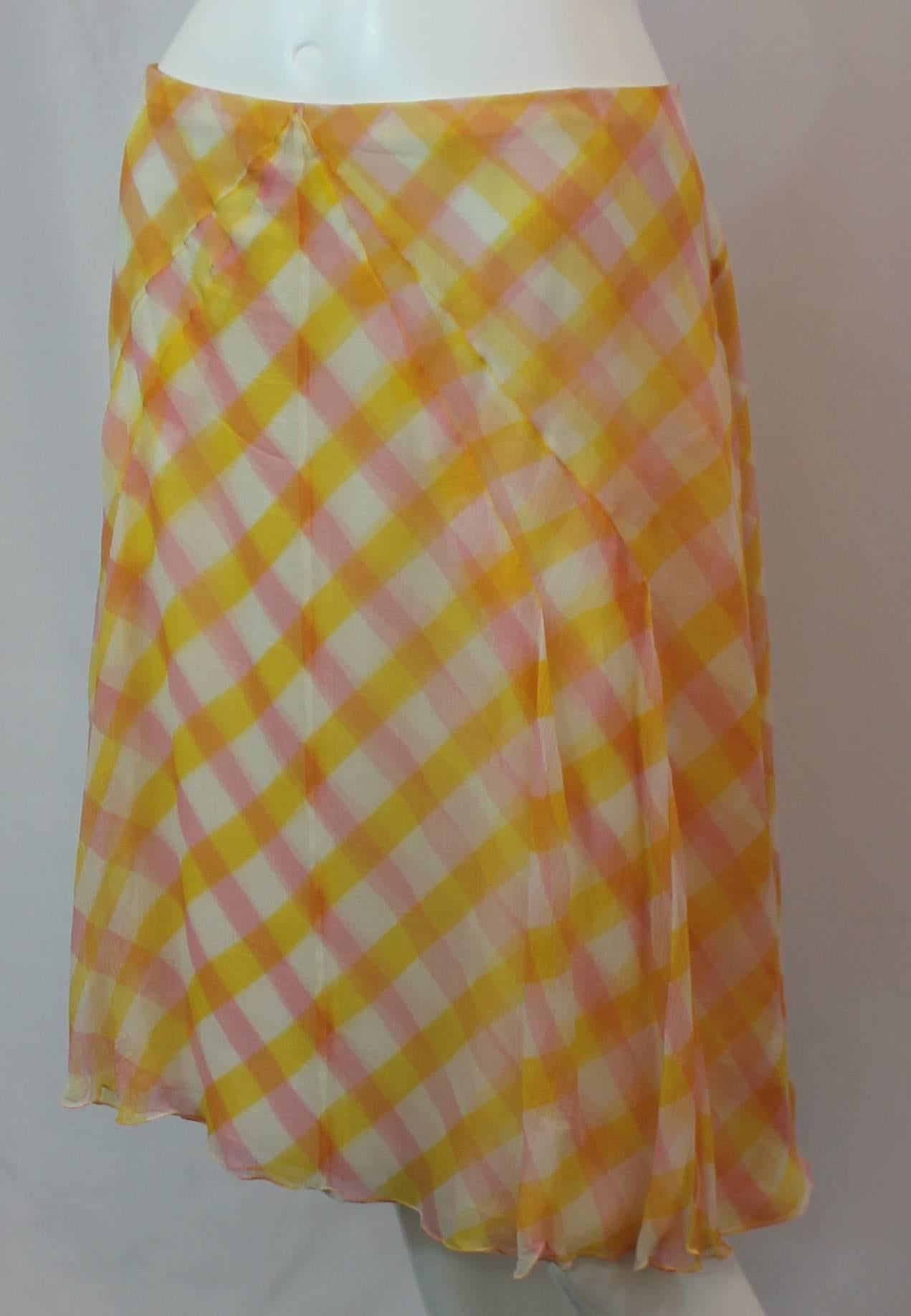 Chanel Yellow, Pink, and White Printed Silk Chiffon Flowing Skirt - 42 - 99C. This skirt has a criss-cross print and has diagonal stitching in the front. There is a back zipper and a white chiffon lining. This skirt is in excellent