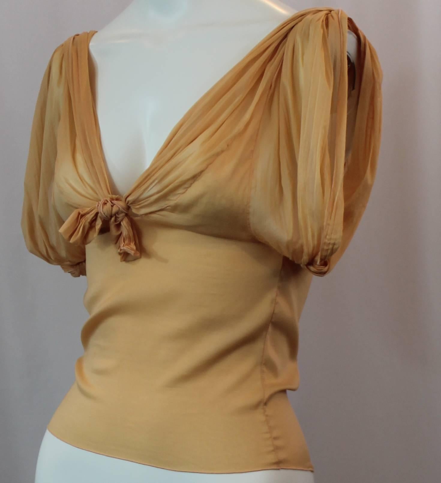 Christian Dior Mustard Colored Silk Ruched Sleeveless Blouse with Ties - S. This ruched sleeveless blouse has a front tie and a decorative back tie/ decoration. There is a plunging neckline and the blouse is made of a stretchy silk material. It is