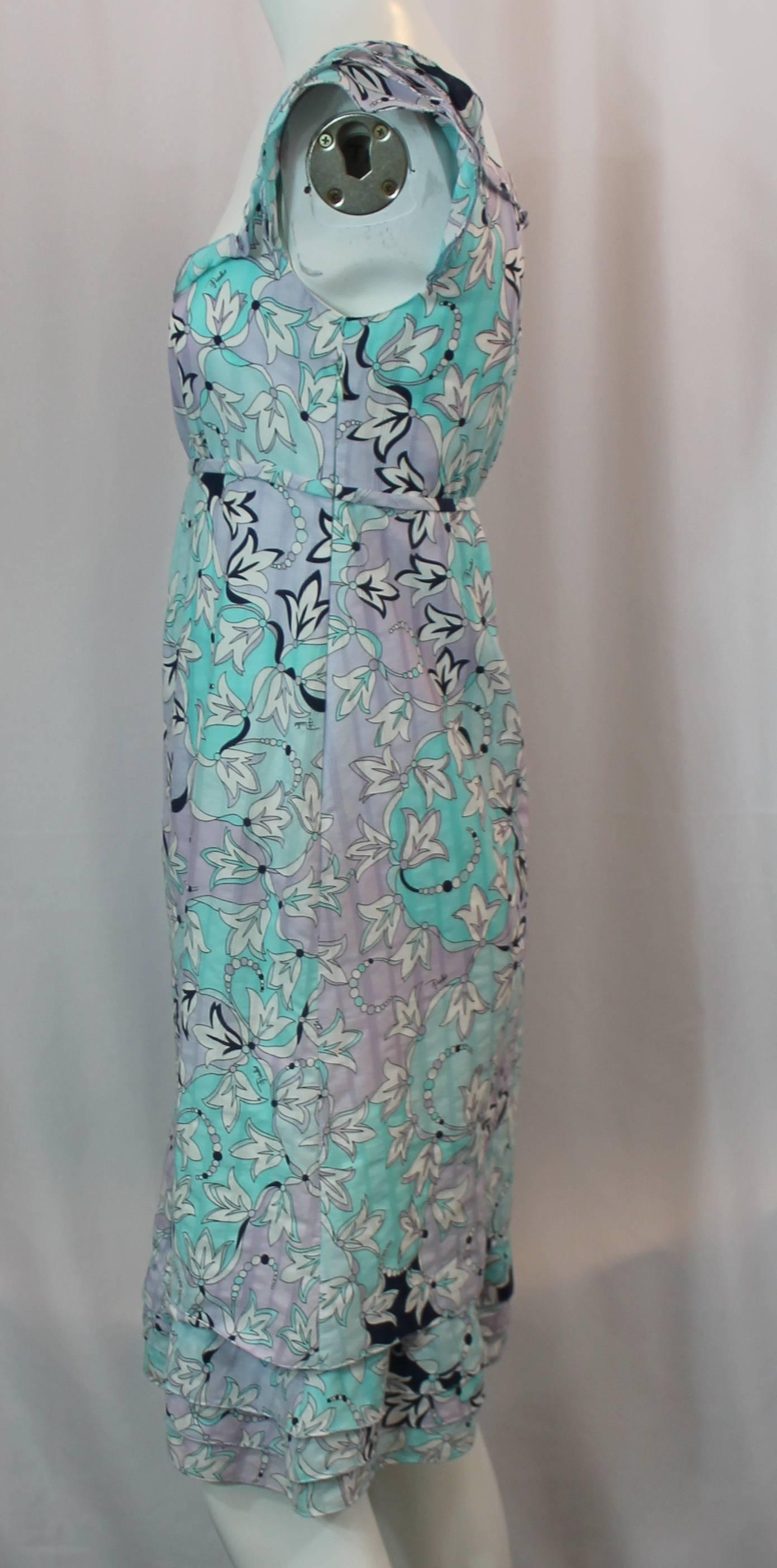 Emilio Pucci Floral Printed Pastel Blue and Lavender Cotton Dress with Cap Sleeves - 4. This loose fitting cotton dress is pastel blue and lavender and has a floral printed. It has cap sleeves with shutter pleats and an empire waist with cascading