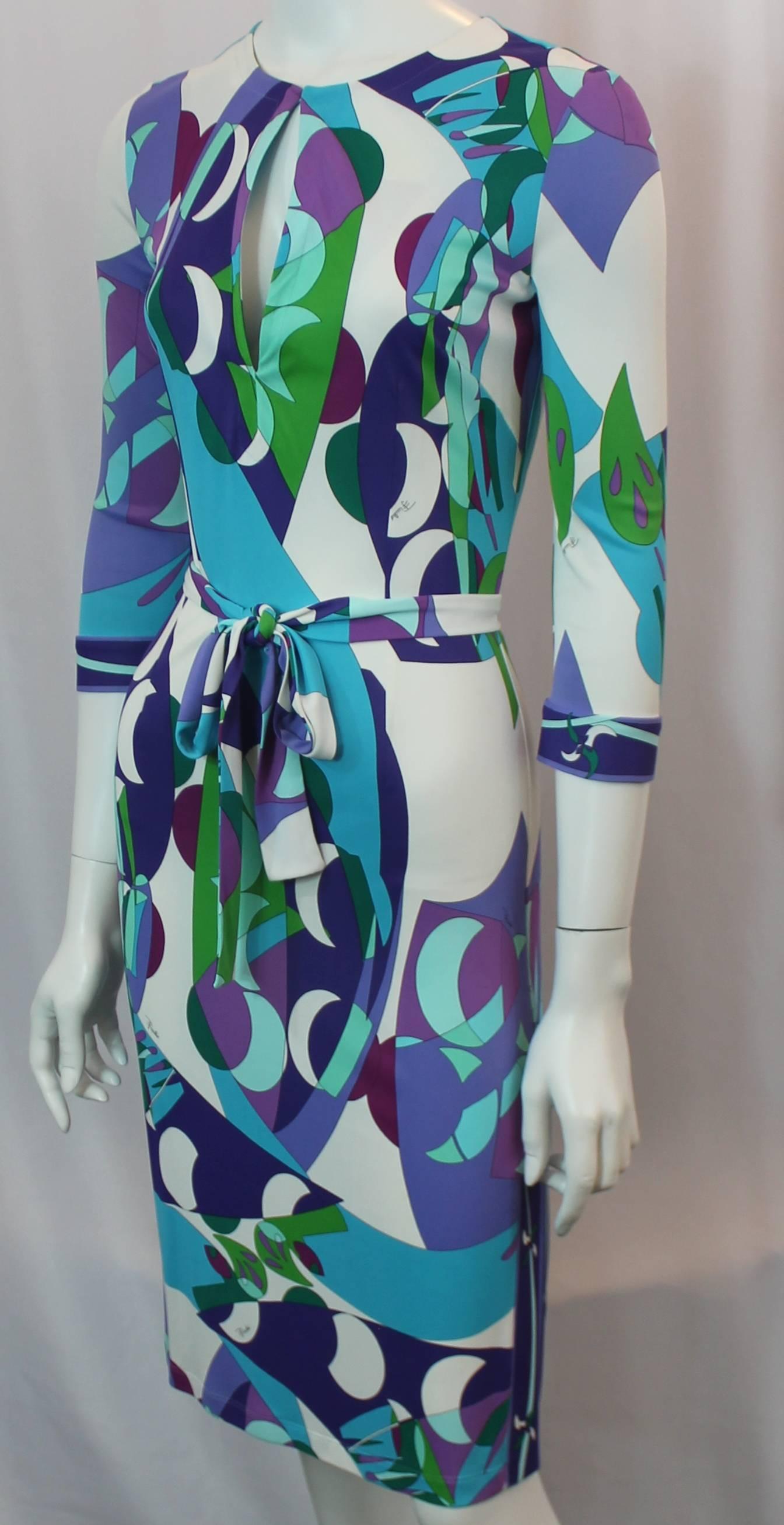 Emilio Pucci Multi-Colored Geometric Print Jersey 3/4 Sleeve Dress - 6.This 3/4 dress is white with a geometric-shape pattern in green, purple, and blue. It has a keyhole cutout which can be worn unbuttoned to look like a collar and a belt is