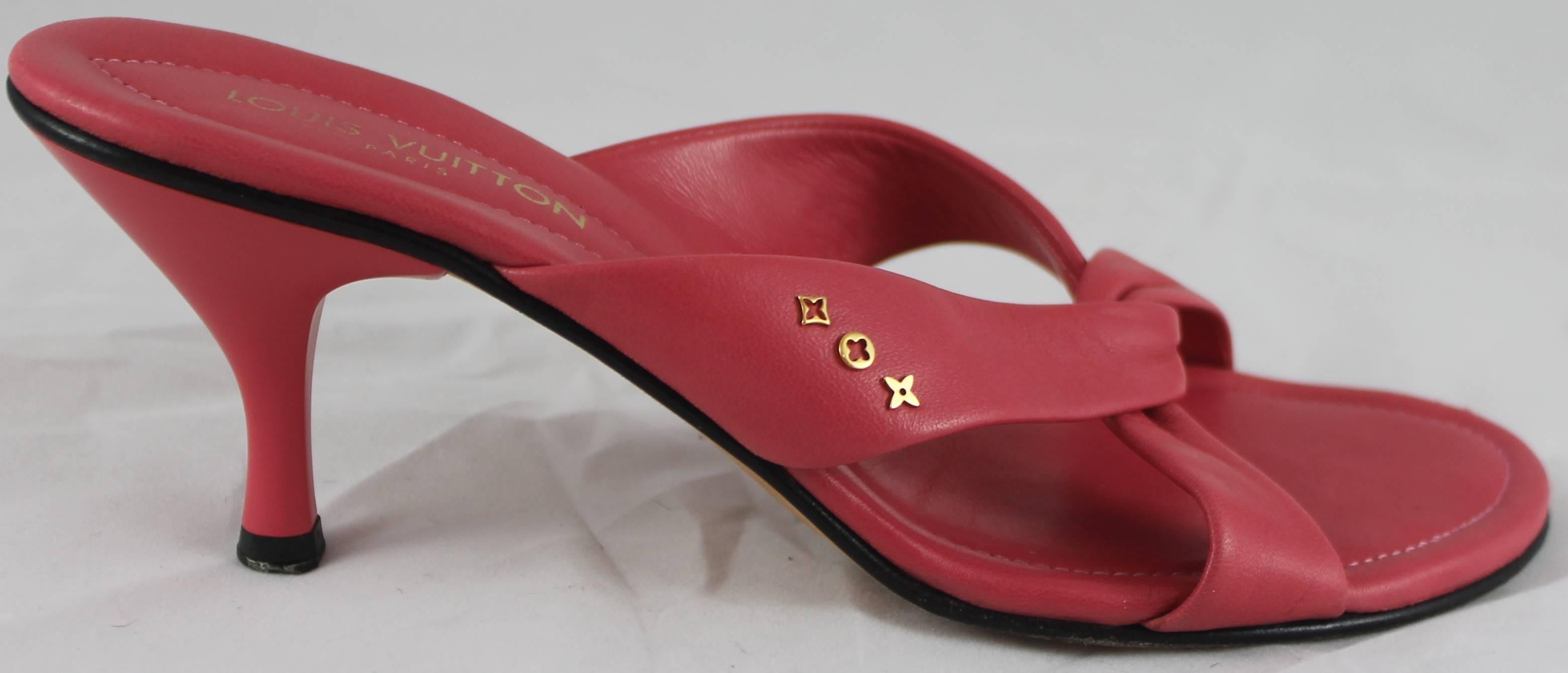 Louis Vuitton Coral Criss-Cross Leather Sandals with Heel and Gold Details - 37. These coral sandal heels have two strips of leather that are criss-crossed and there are some Louis Vuitton emblem gold metal details on the sides. These shoes are in