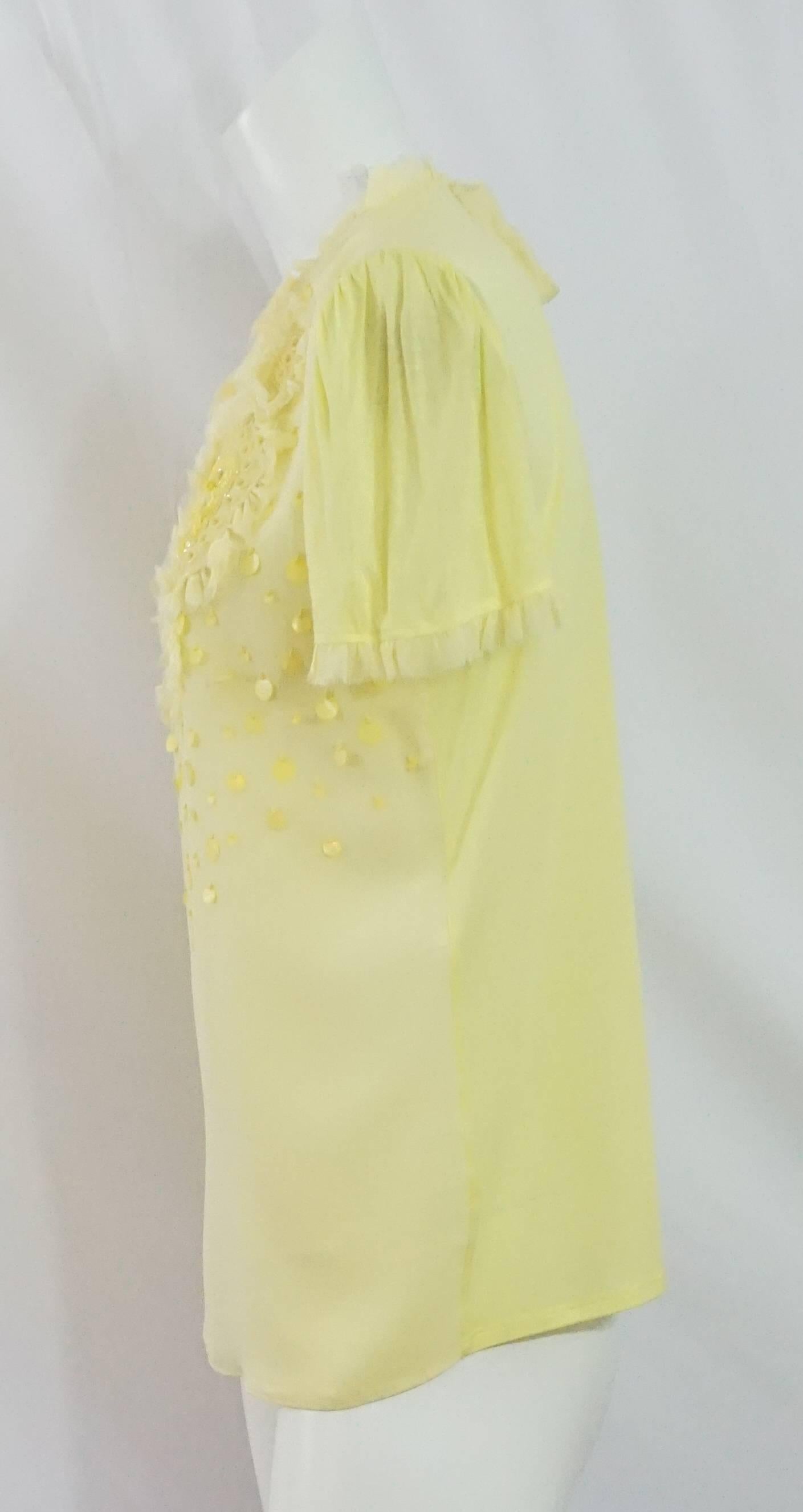 Emilio Pucci Yellow Cotton & Silk Beaded Short Sleeve Top - 10. This top is gorgeous and perfect for warm weather! It features an embellished front with geometric beading and ruffles, hanging palette sequins, a silk front, a cotton back, sleeve