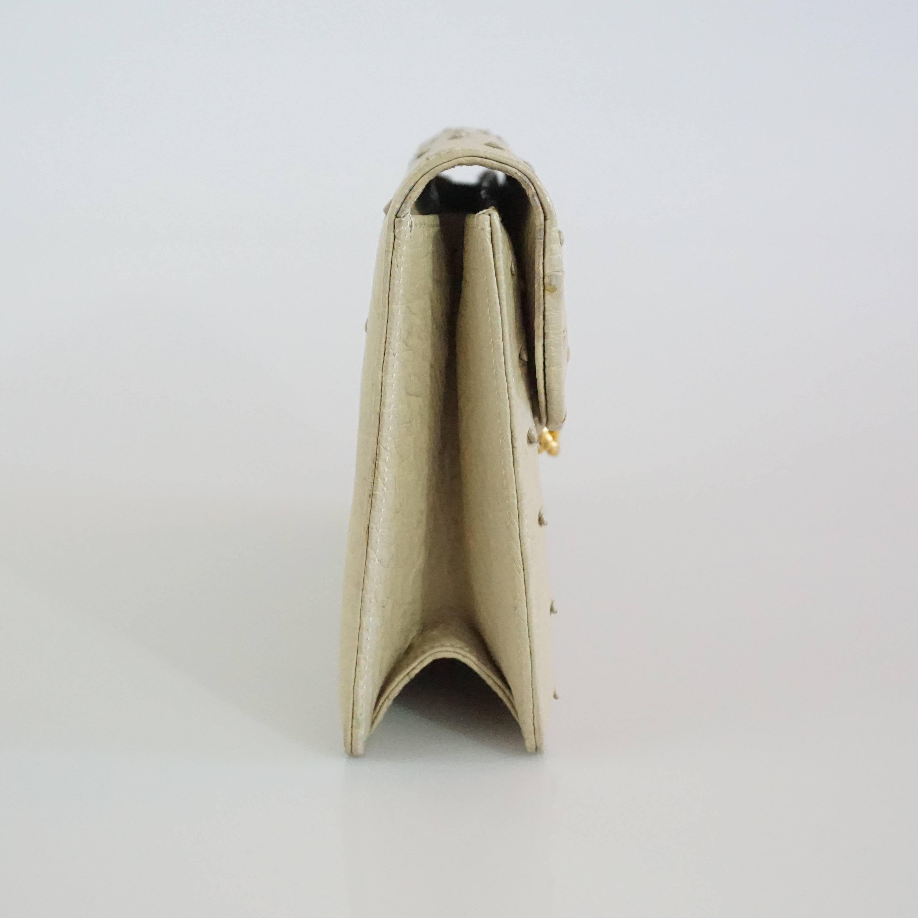 Gucci Bone Ostrich Envelope Clutch with Gold Clasp - 1950's. This classic clutch features a gold rope clasp, tan leather lining, 3 interior pockets, 2 small pockets, and a hard shape allowing it to stand on its own. This clutch is in excellent
