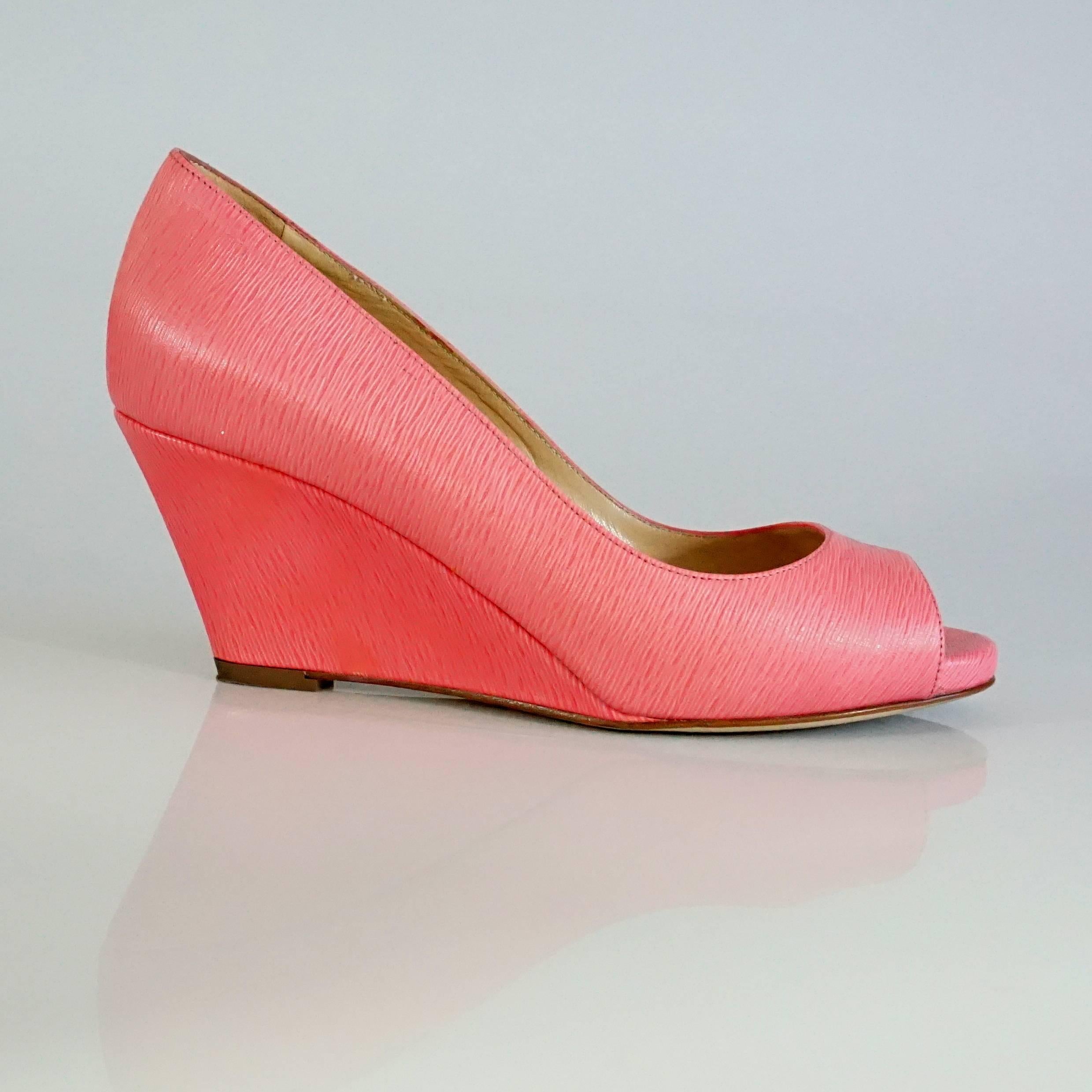 Sergio Rossi Pink Epi Leather Open Toe Wedges - 36.5. These shoes are in excellent condition with light wear and some bottom wear. They are the perfect pop of color for any outfit and features a slender, sleek fit.

Measurements:
Wedge-