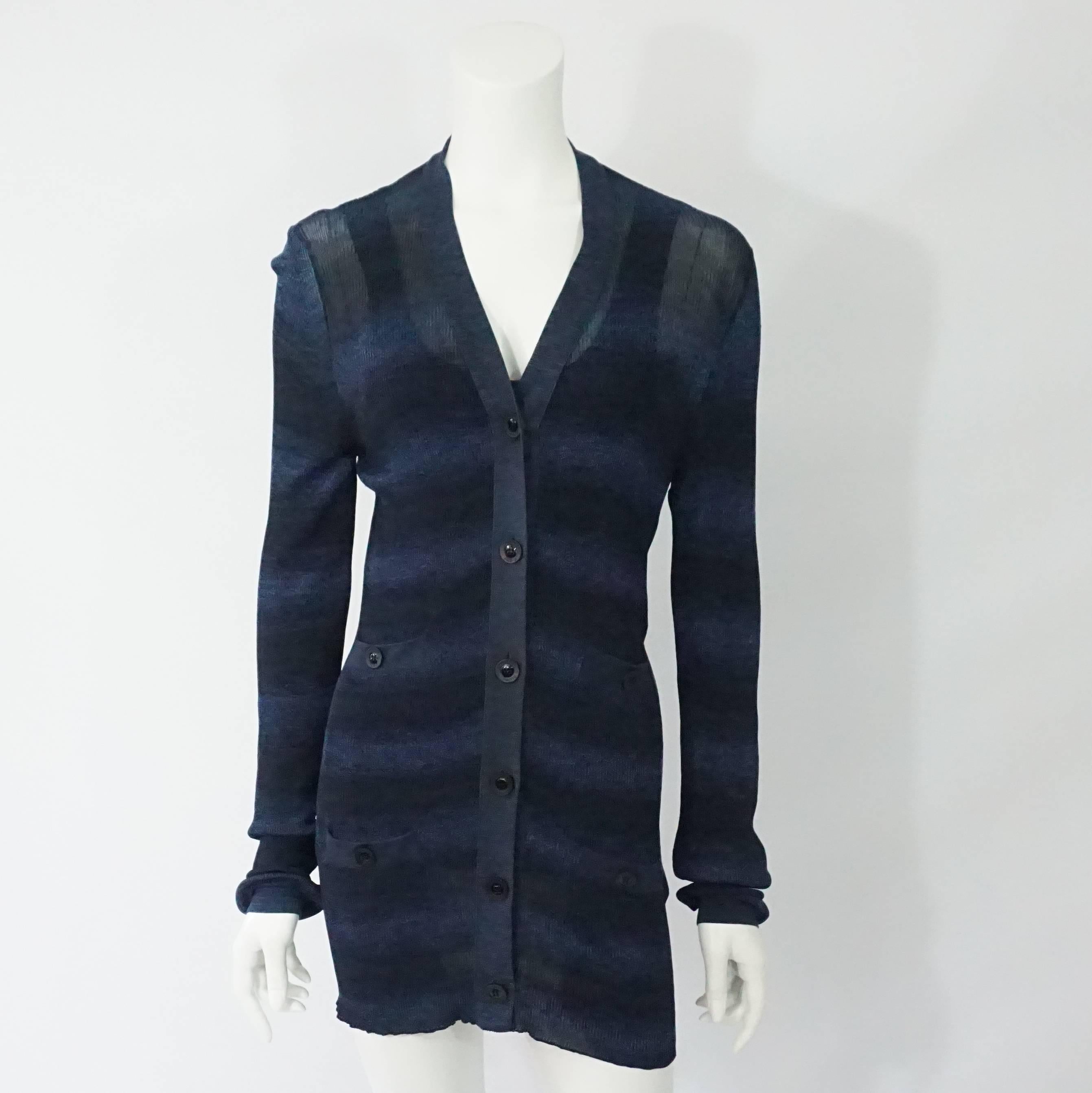 Chanel Two Tone Stripe Navy Long Sweater Set - 42  This very elegant navy sweater set has two tones of navy blue with horizontal thick stripes and a metallic stitching within the knit. The inside piece is a sleeveless top, and the cardigan is long.