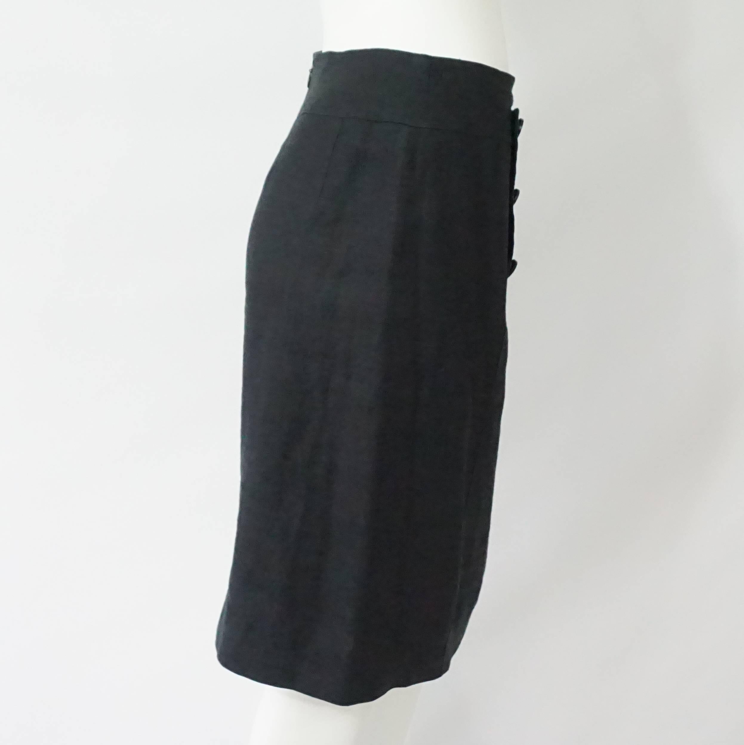 Chanel Black Linen Nautical Style Skirt - 36 - Circa 80's  This black linen skirt has 8 front Chanel logo buttons with a nautical style design, a back slit and is perfect piece for any Chanel collector. It is in excellent vintage