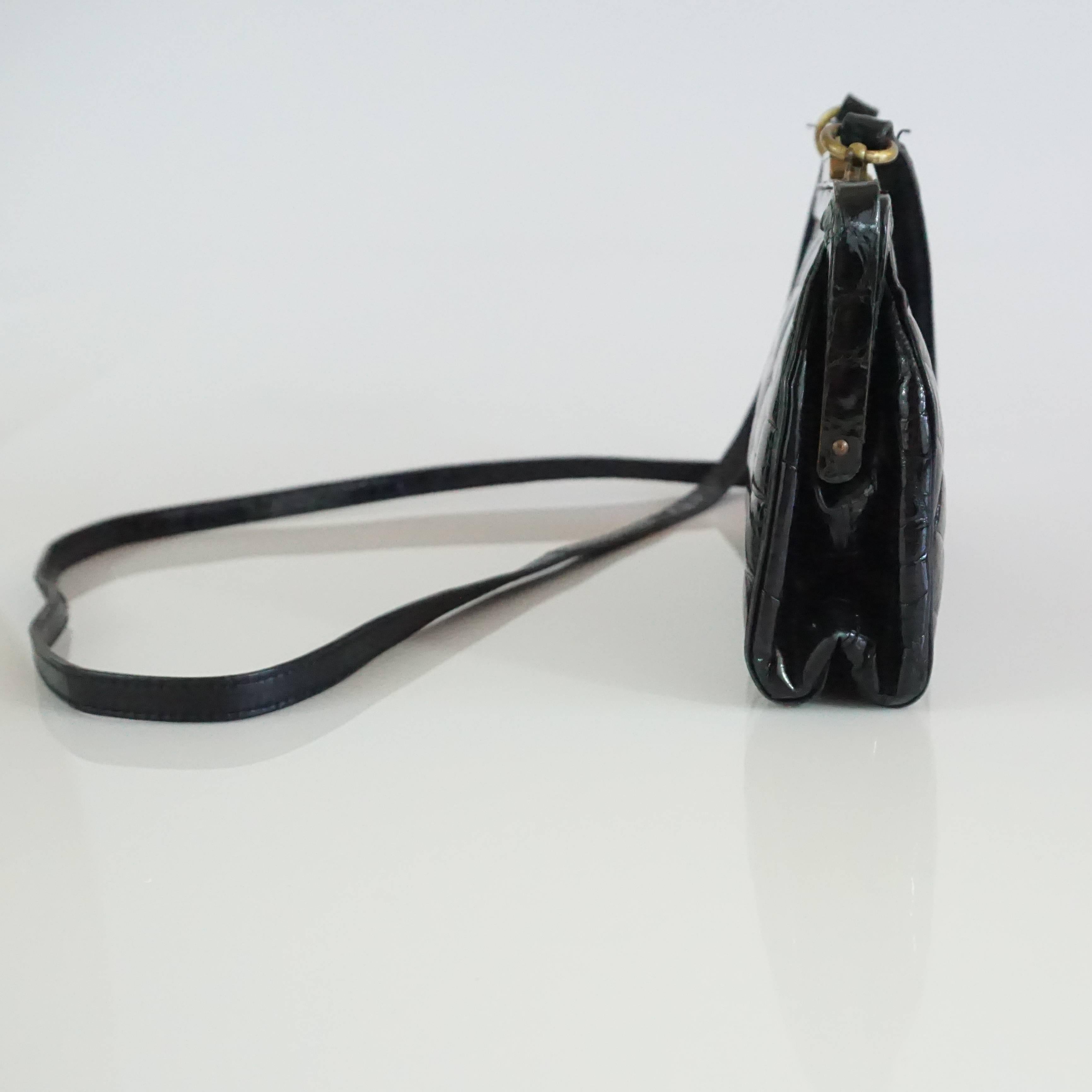 Marino Black Alligator Crossbody Bag - 1990's. This bag is a timeless piece that is just a trendy now as it was in the 90's. It features a long leather strap, gold hardware, a slide closure, black leather lining, and one interior pocket. It is in